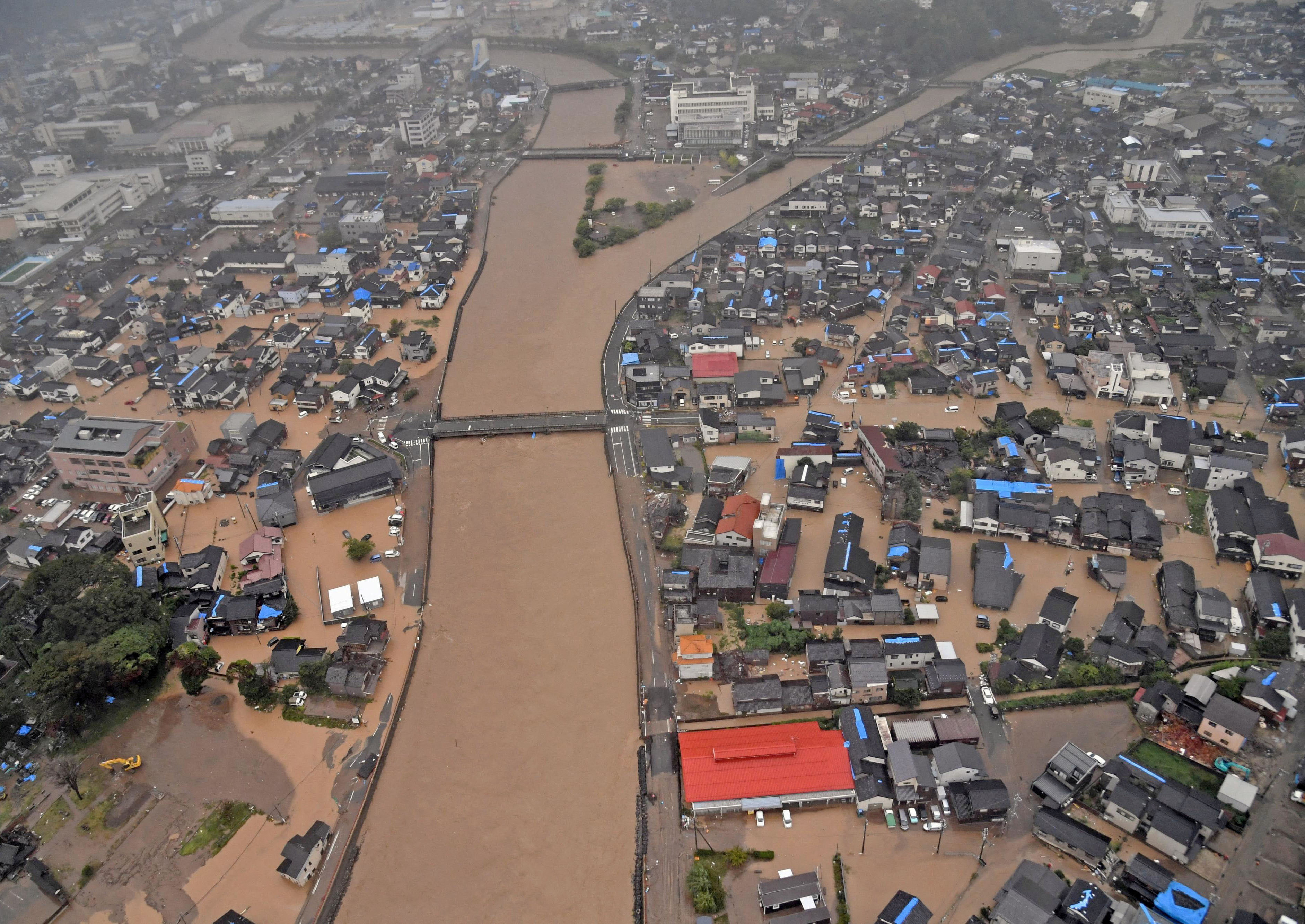Rescuers comb muddy riverbanks after Japan floods kill six