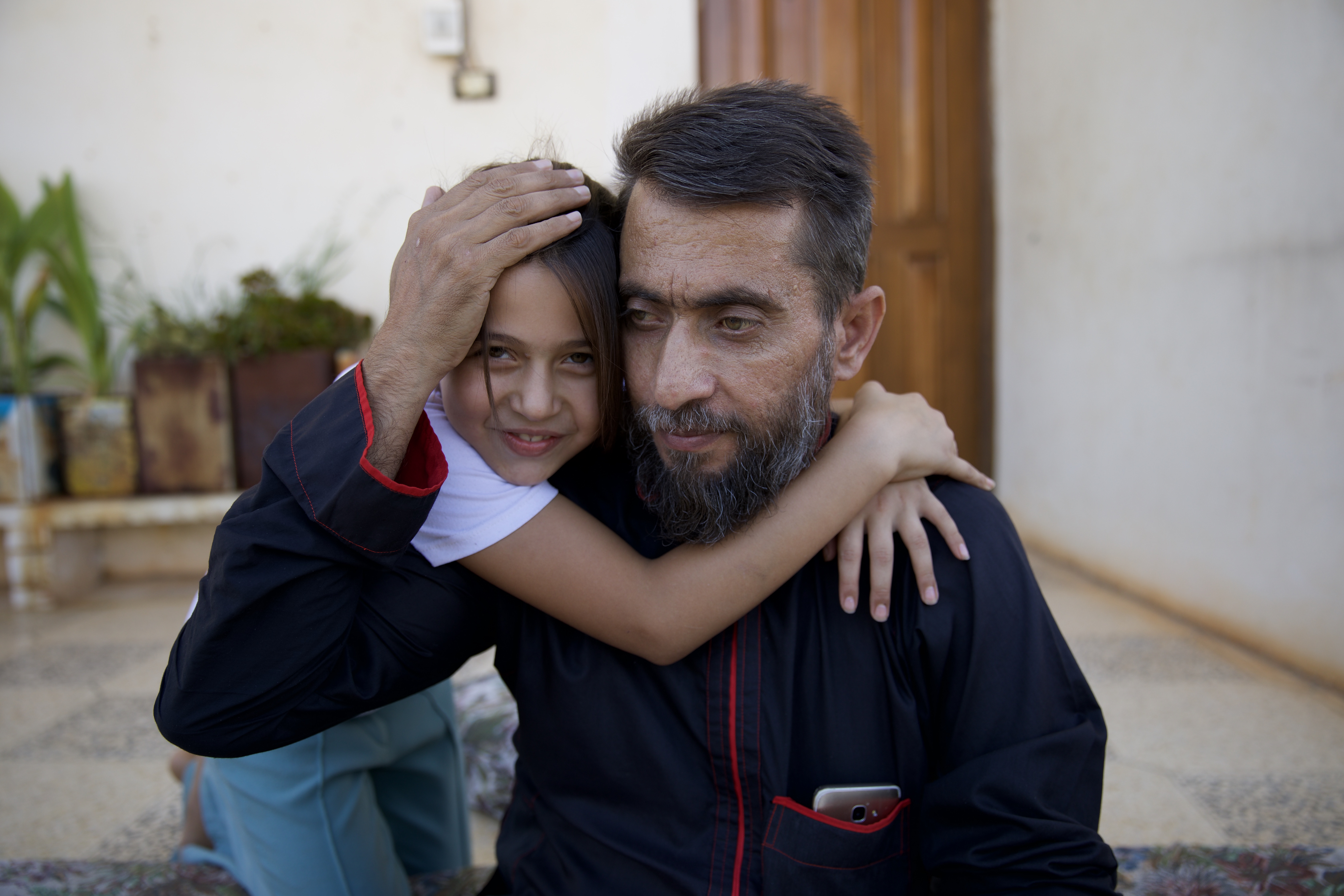 Ayman al-Khayal’s daughter Madiha tries to keep her father’s spirits up during his hours-long dialysis sessions in Bab al-Hawa Hospital, Idlib, Syria