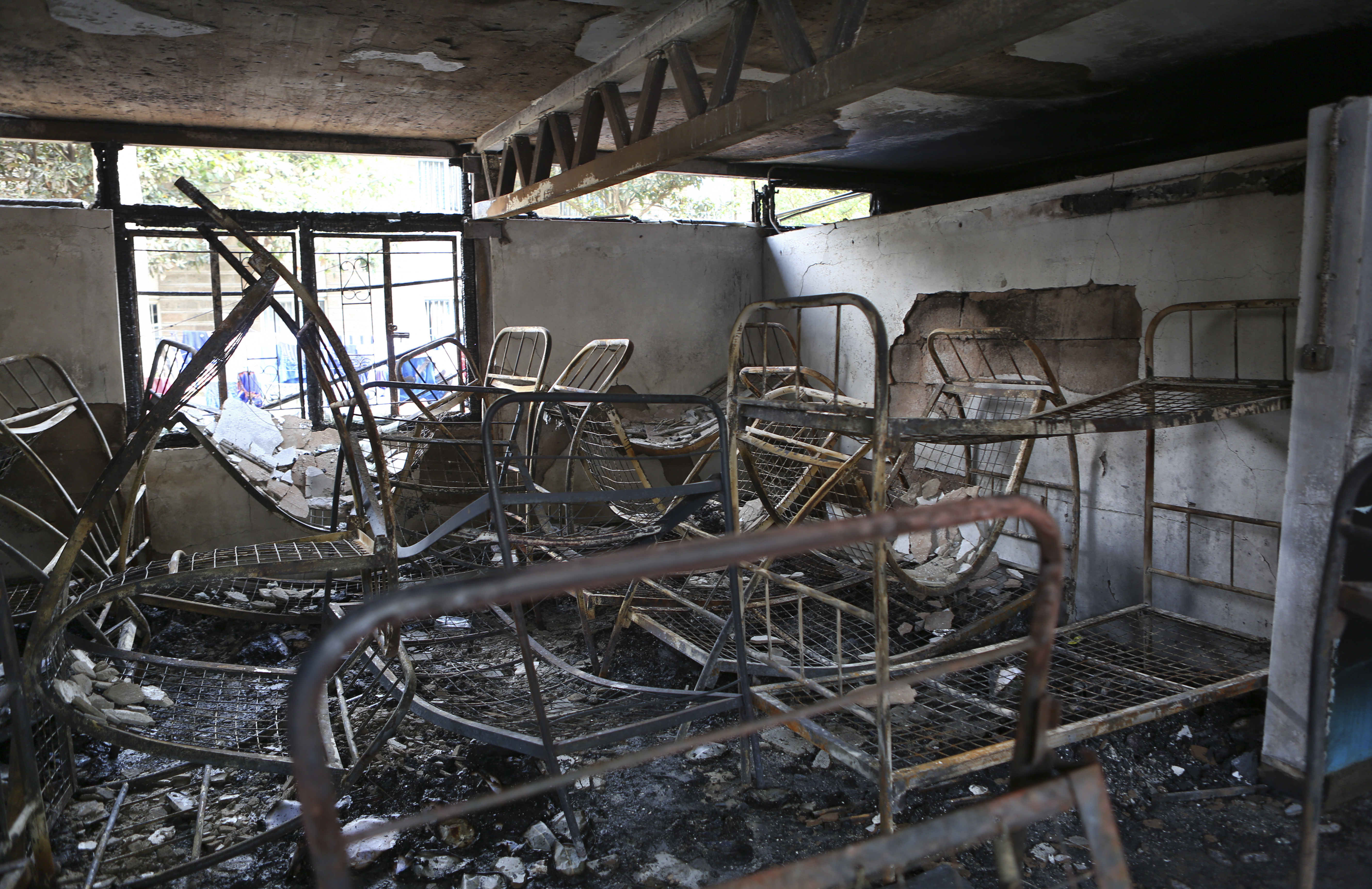 Metal bed frames are seen in a burned-out dormitory after a fire at the Moi Girls High School in Nairobi, Kenya, on September 2, 2017