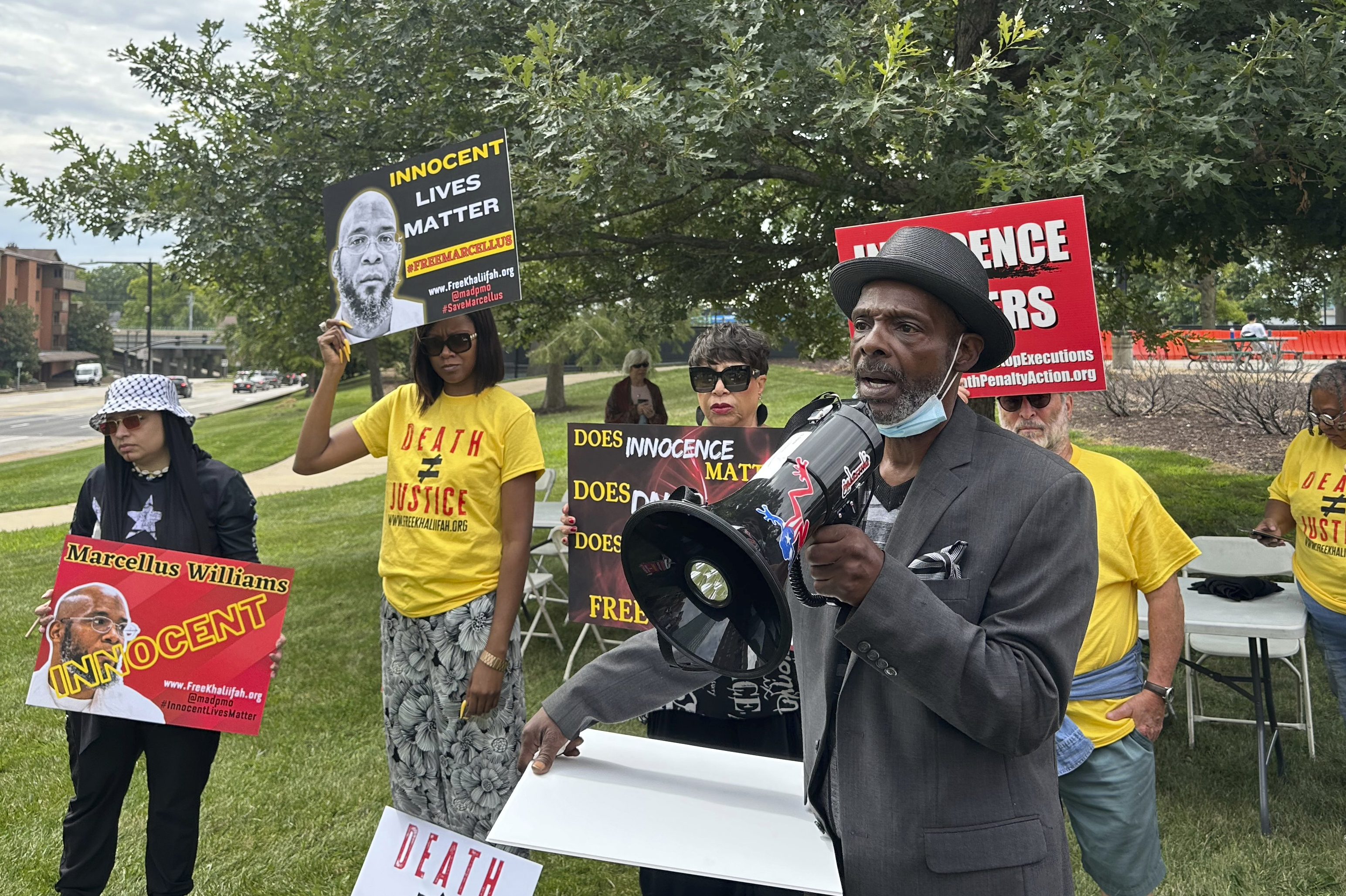 People rallying in support of Marcellus Williams. They are carrying placards saying he is innocent. Joseph Amrine, who was exonerated two decades ago after spending years on death row, is speaking.