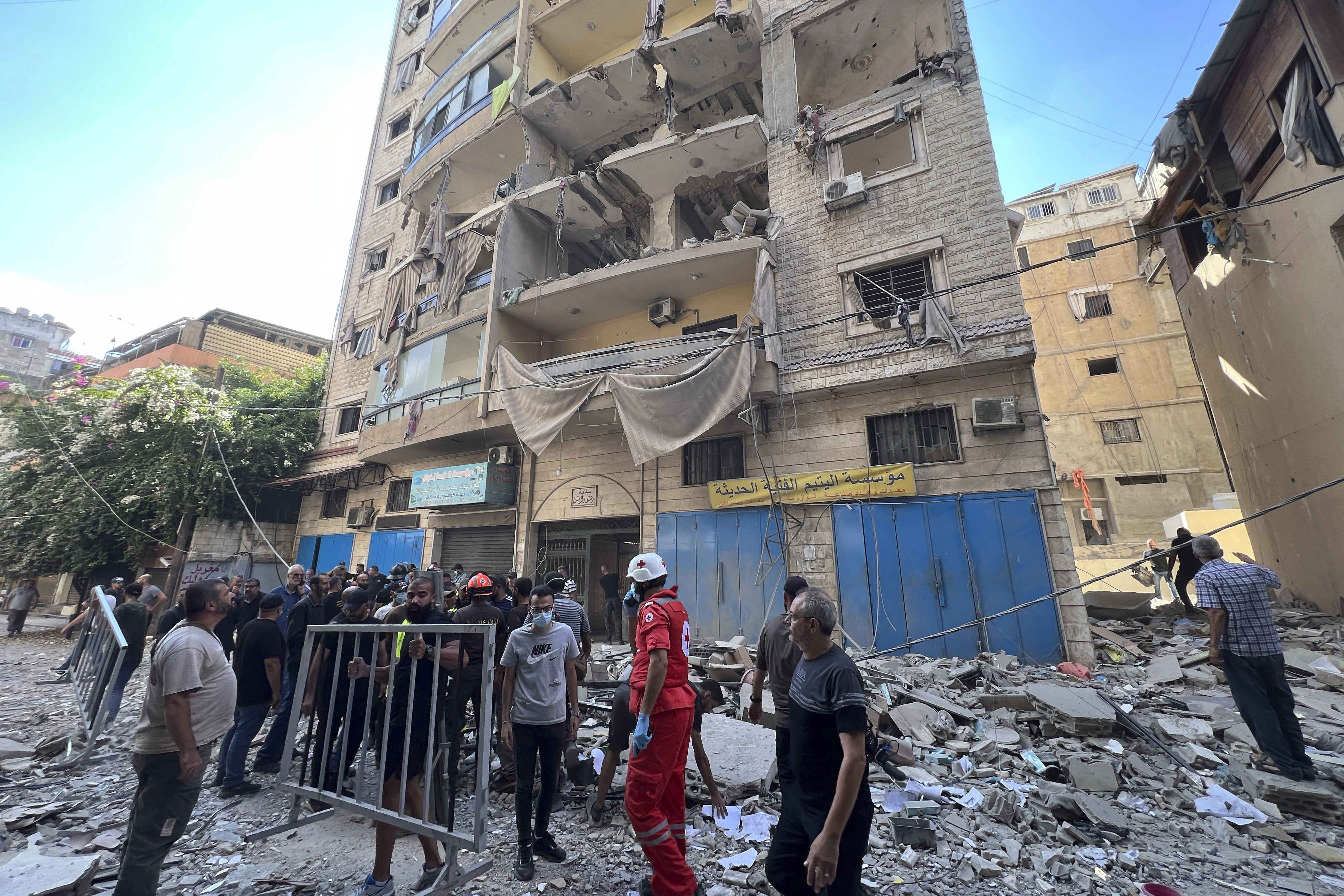 Rescuers arrive at the scene of an Israeli airstrike in Beirut's suburb of Ghobeiri,