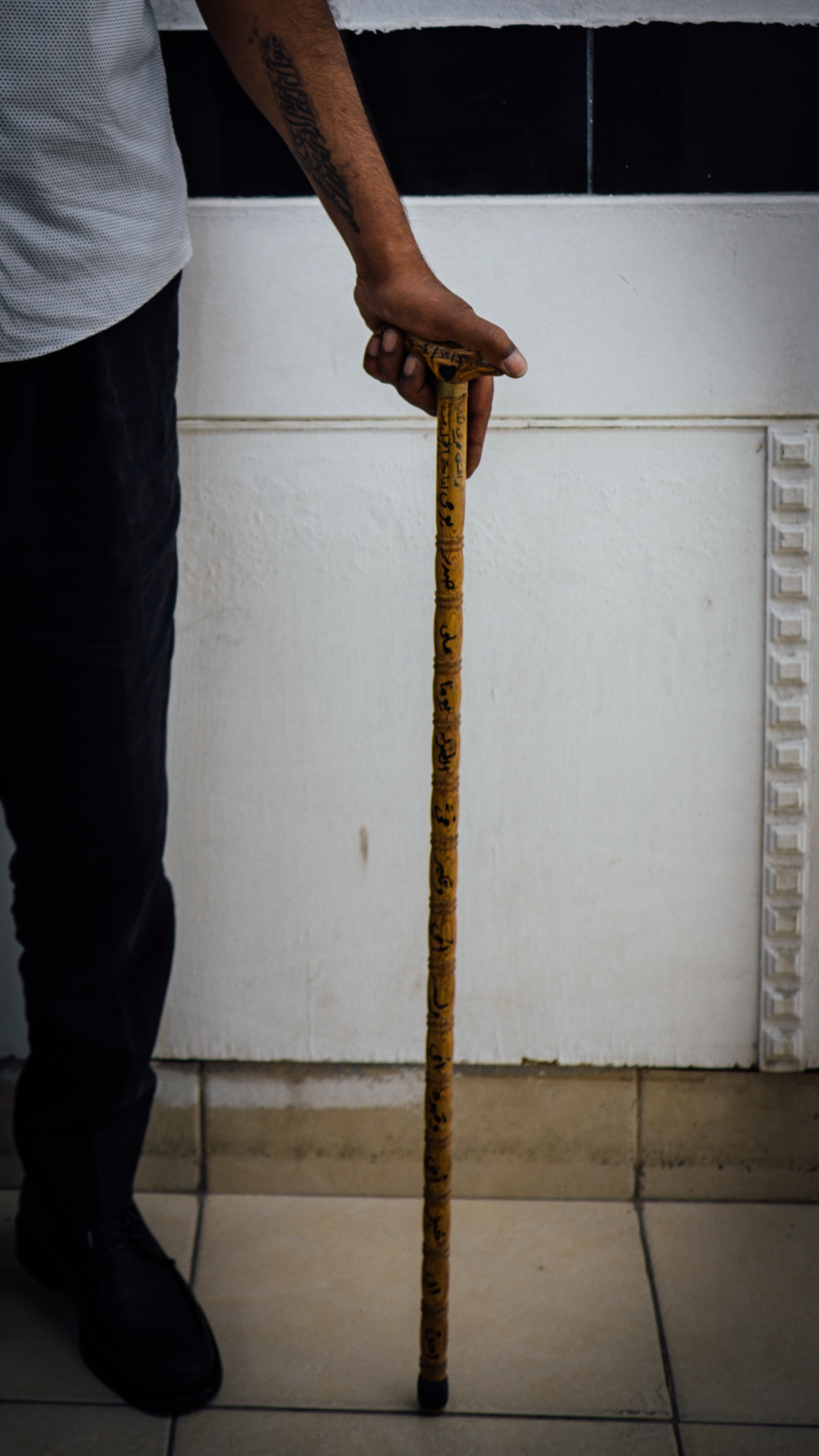 Ihsan Mohamad Yaseen holds his mother's walking stick
