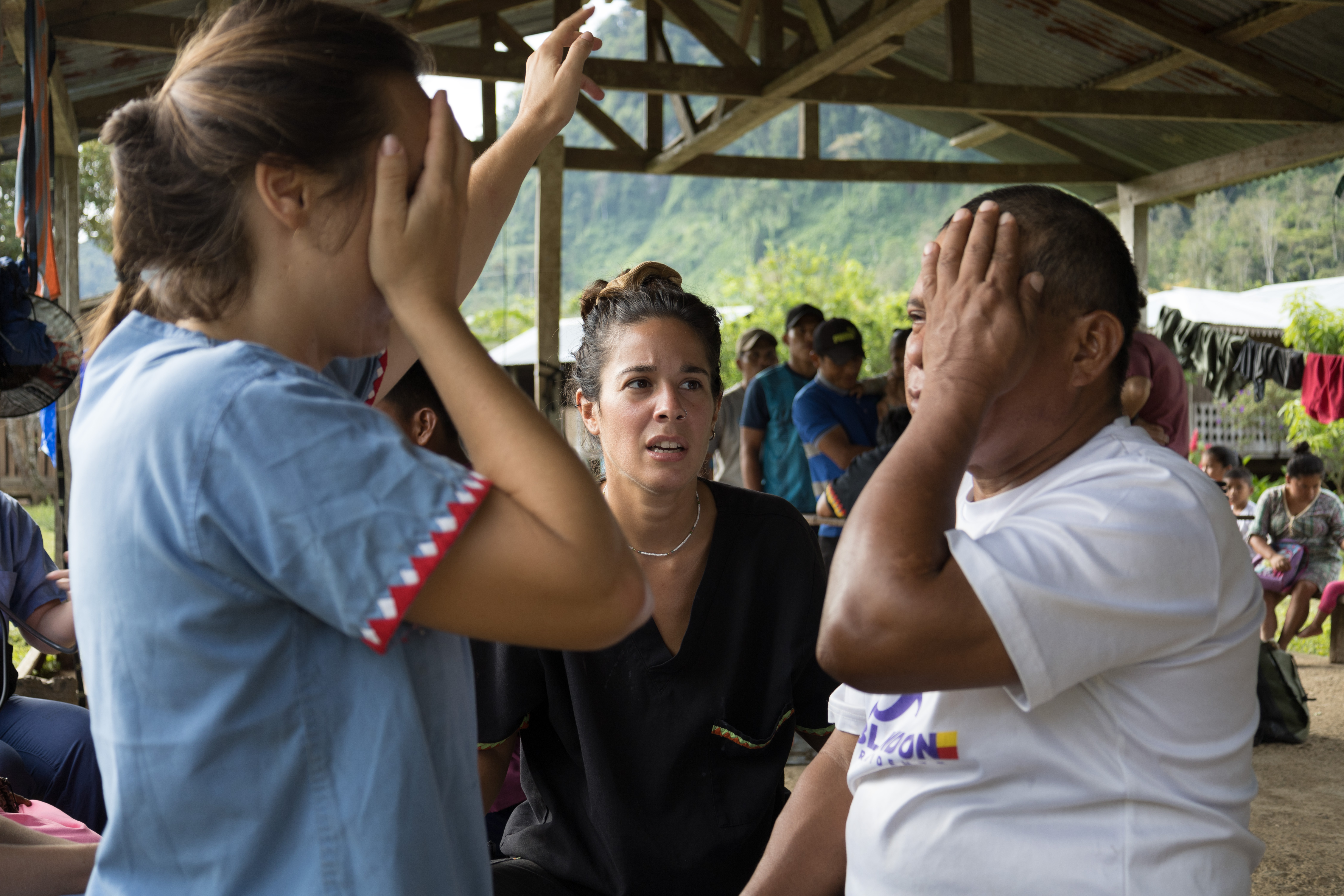 Victoria Corvera Pose (centre), a Floating Doctors team member from Argentina, and Iris Ertugrul conduct a vision exam in the village of La Sabana
