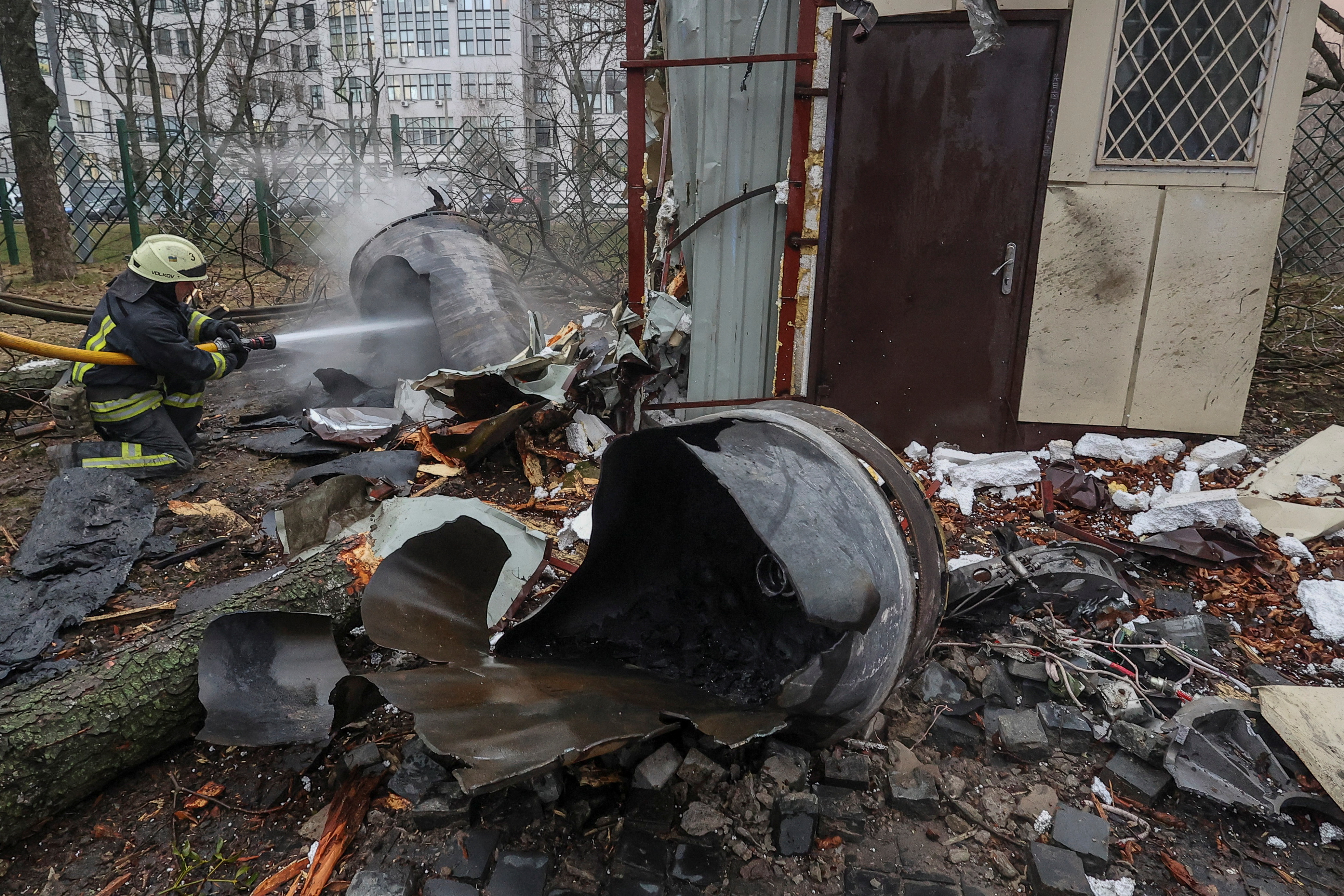 A firefighter extinguishes remains of an unidentified missile, which Ukrainian authorities claimed to be made in North Korea, at a site of a Russian strike, amid Russia's attack on Ukraine, in Kharkiv, Ukraine January 2, 2024. REUTERS/Vyacheslav Madiyevskyy