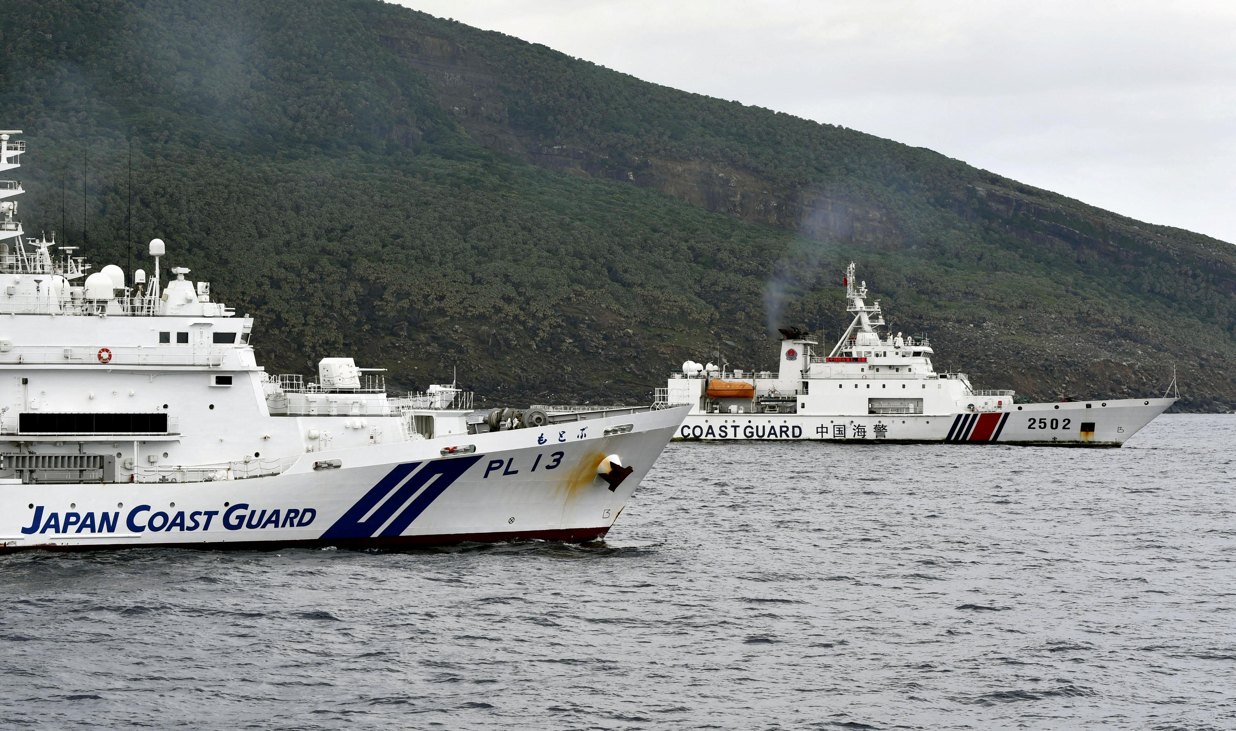 A China Coast Guard vessel No.2502 sails near a Japan Coast Guard vessel Motobu off Uotsuri Island, one of a group of disputed islands called Senkaku Islands in Japan, also known in China as Diaoyu Islands, in the East China Sea April 27, 2024, in this photo released by Kyodo. Mandatory credit Kyodo/via REUTERS ATTENTION EDITORS - THIS IMAGE HAS BEEN SUPPLIED BY A THIRD PARTY. MANDATORY CREDIT. JAPAN OUT. NO COMMERCIAL OR EDITORIAL SALES IN JAPAN.