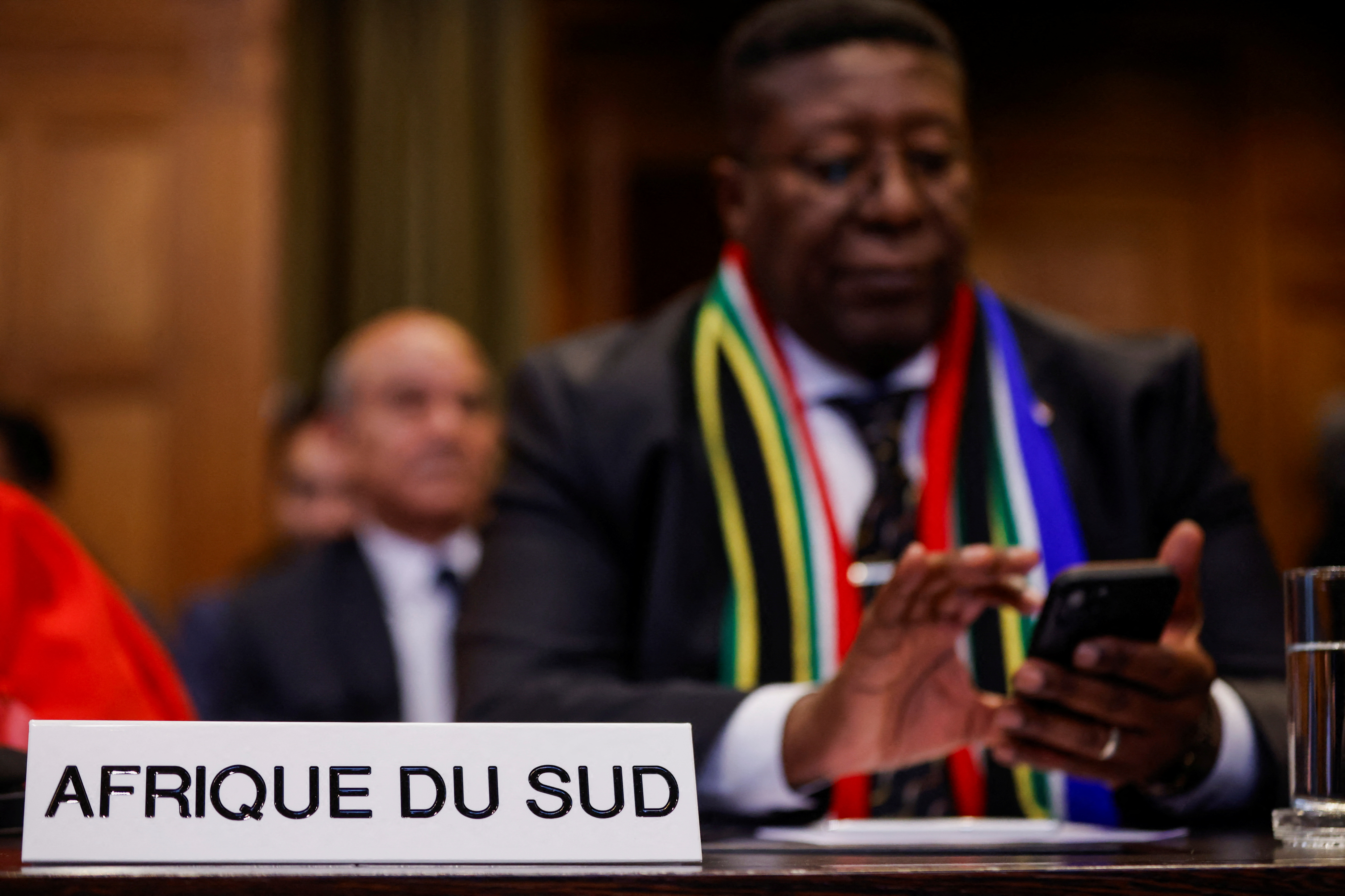South African Ambassador to the Netherlands Vusimuzi Madonsela uses a phone at the International Court of Justice (ICJ), during a ruling on South Africa's request to order a halt to Israel's Rafah offensive in Gaza as part of a larger case brought before the Hague-based court by South Africa accusing Israel of genocide, in The Hague, Netherlands May 24, 2024. REUTERS/Johanna Geron