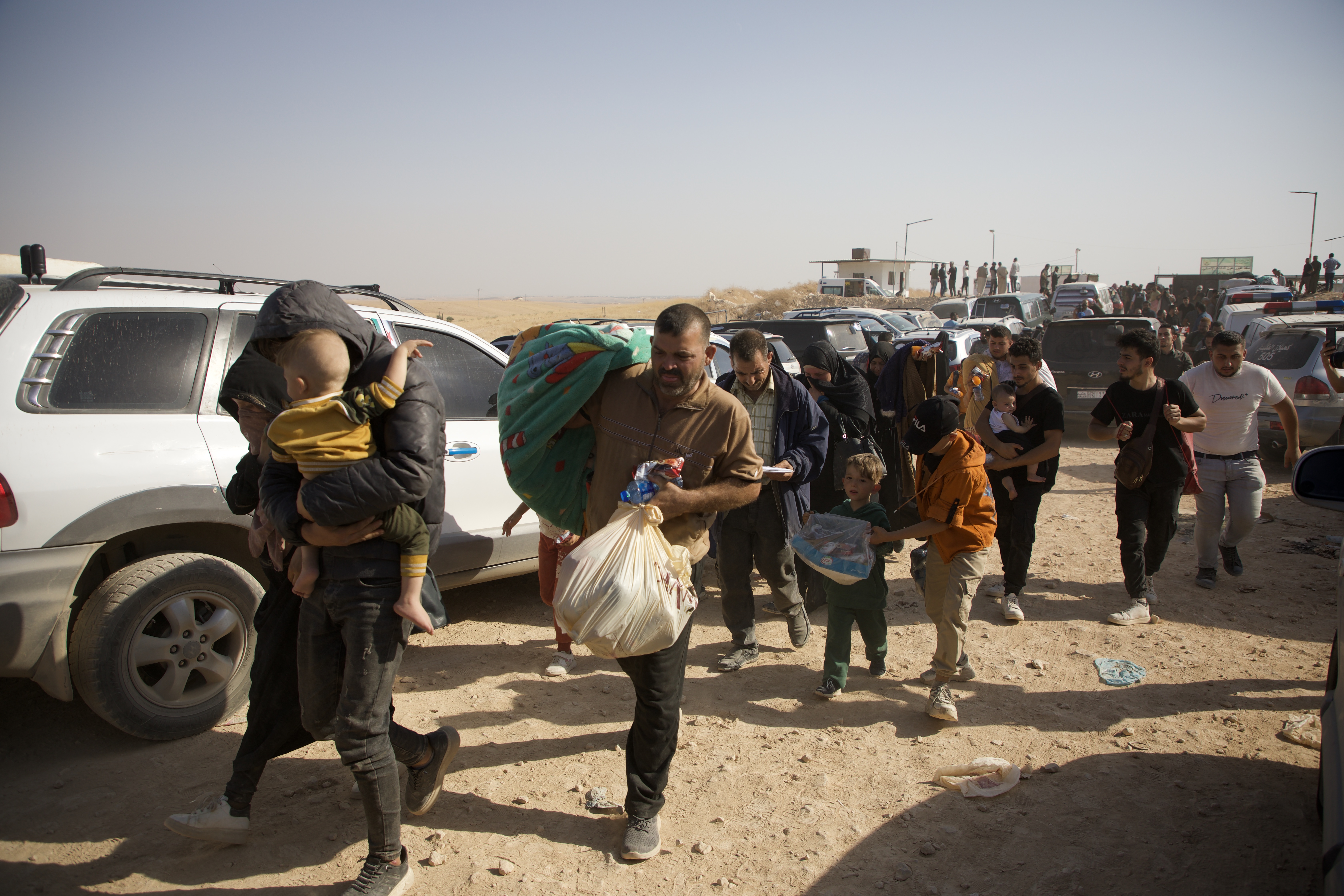 Civilians fleeing Lebanon in the moments after crossing into the Syrian opposition-held area after the Aoun crossing in Aleppo countryside, on October 9, 2024