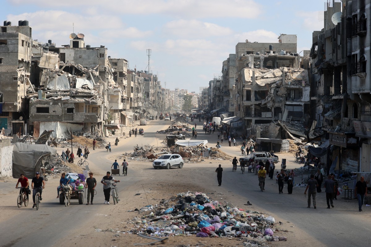 Palestinians carry their belongings as they flee