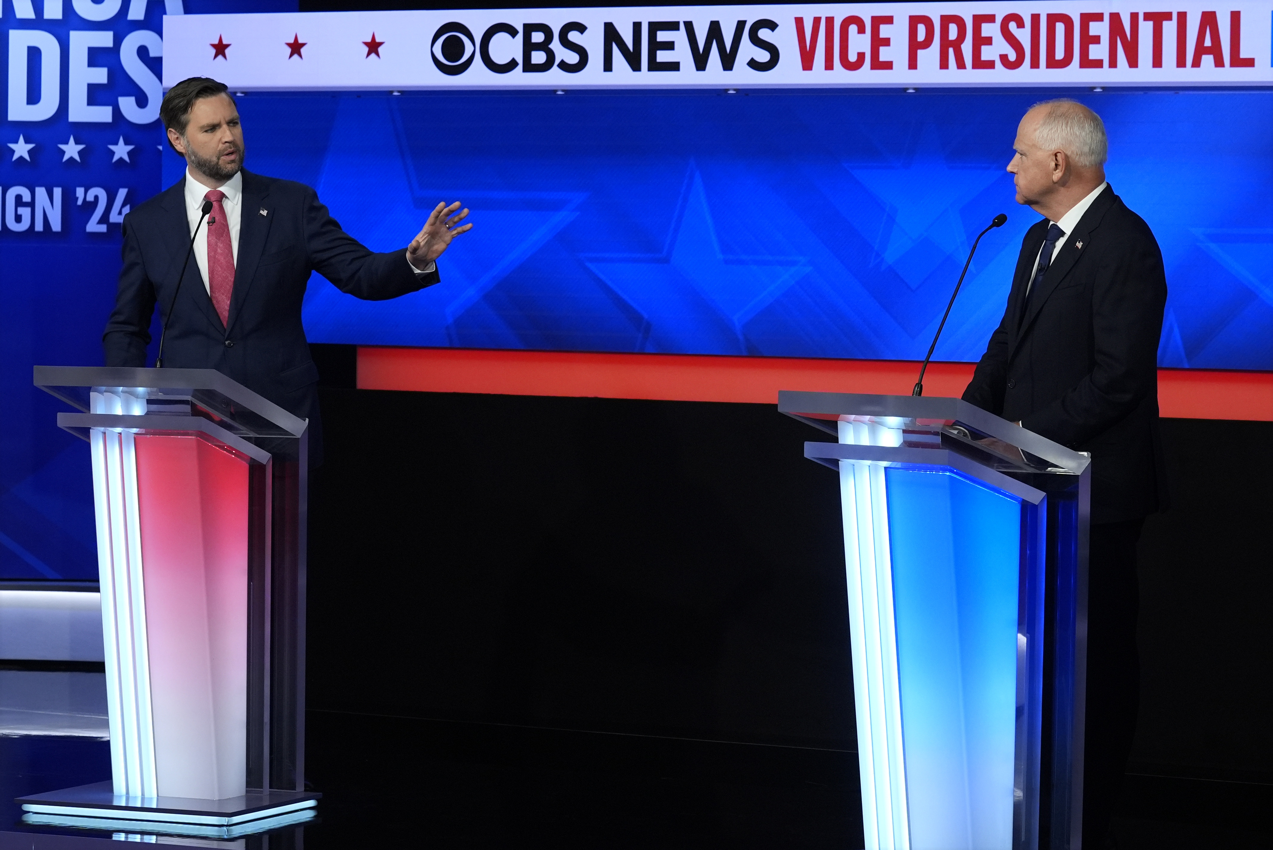 JD Vance and Tim Walz debate on a TV stage