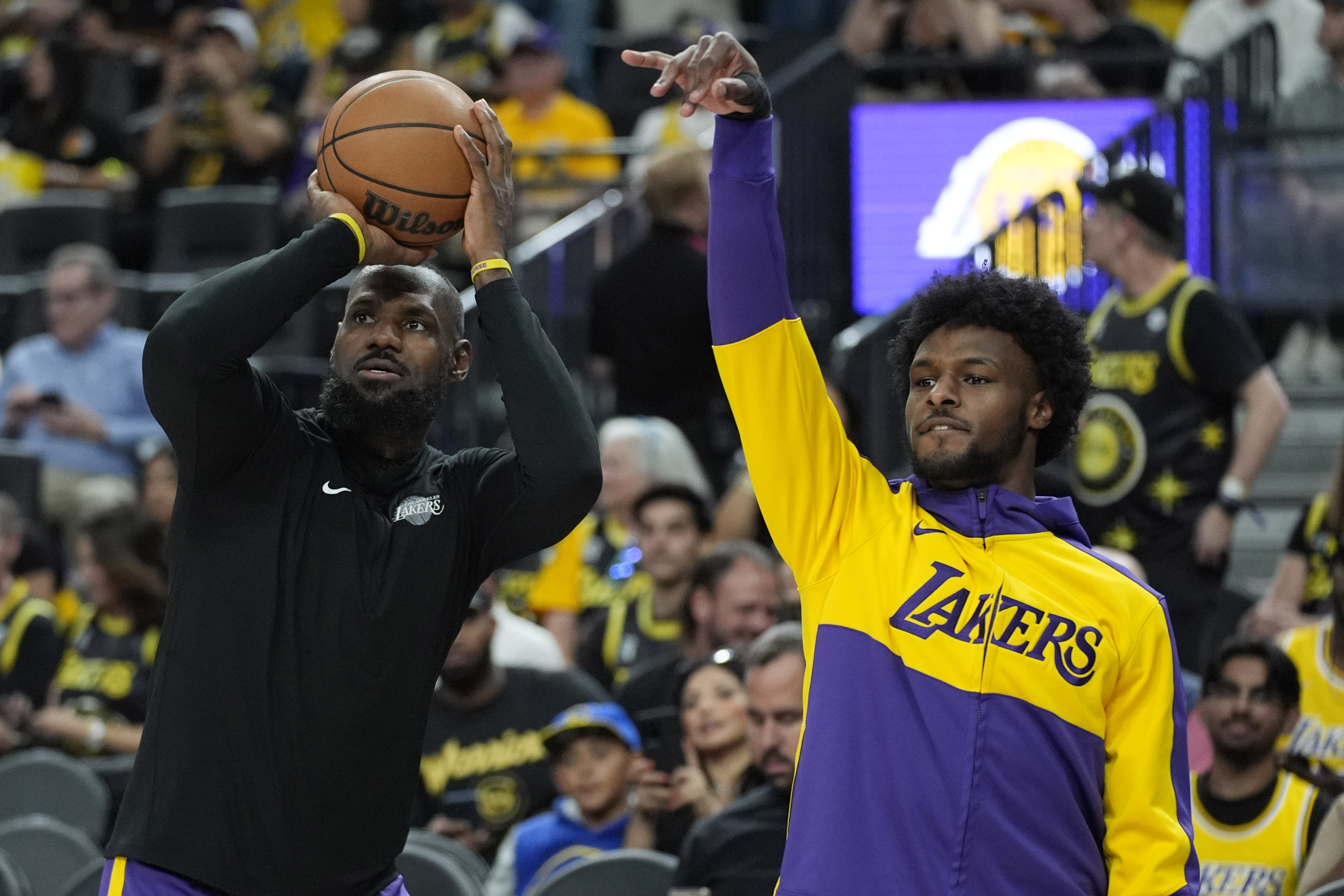 LeBron and Bronny James on court.