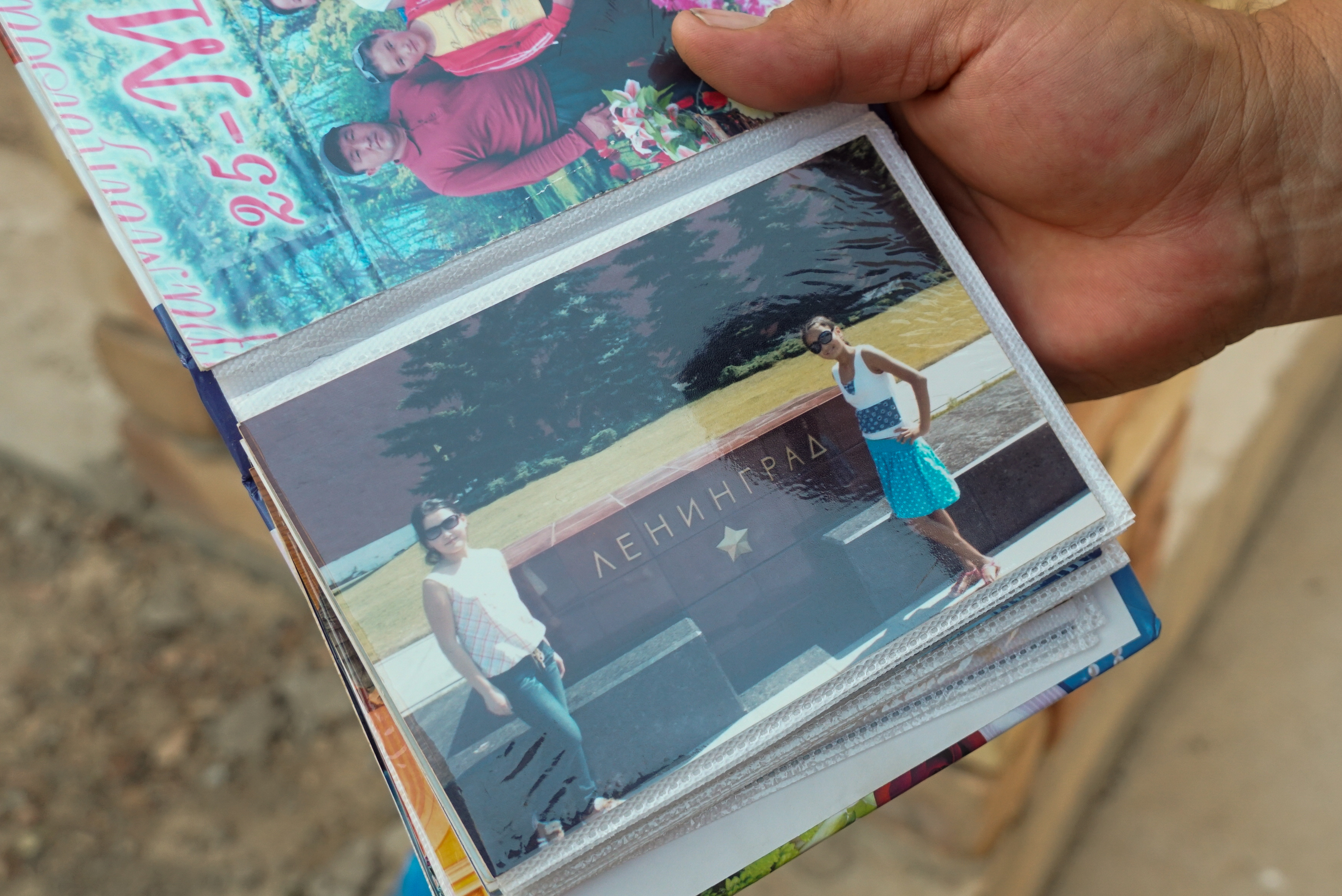 Talantbek shows a picture of Mediyana, left, and a friend visiting Saint Petersburg around 2011 [Aidai Tokoeva and Savia Hasanova]