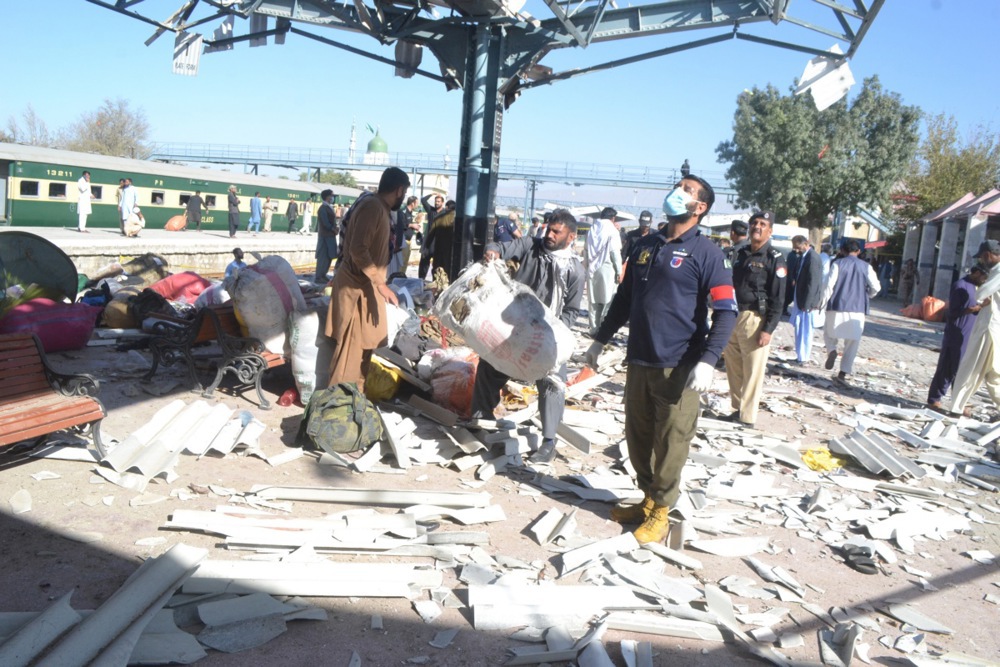 Pakistani security officials inspect the scene of a blast at a railway station in Quetta