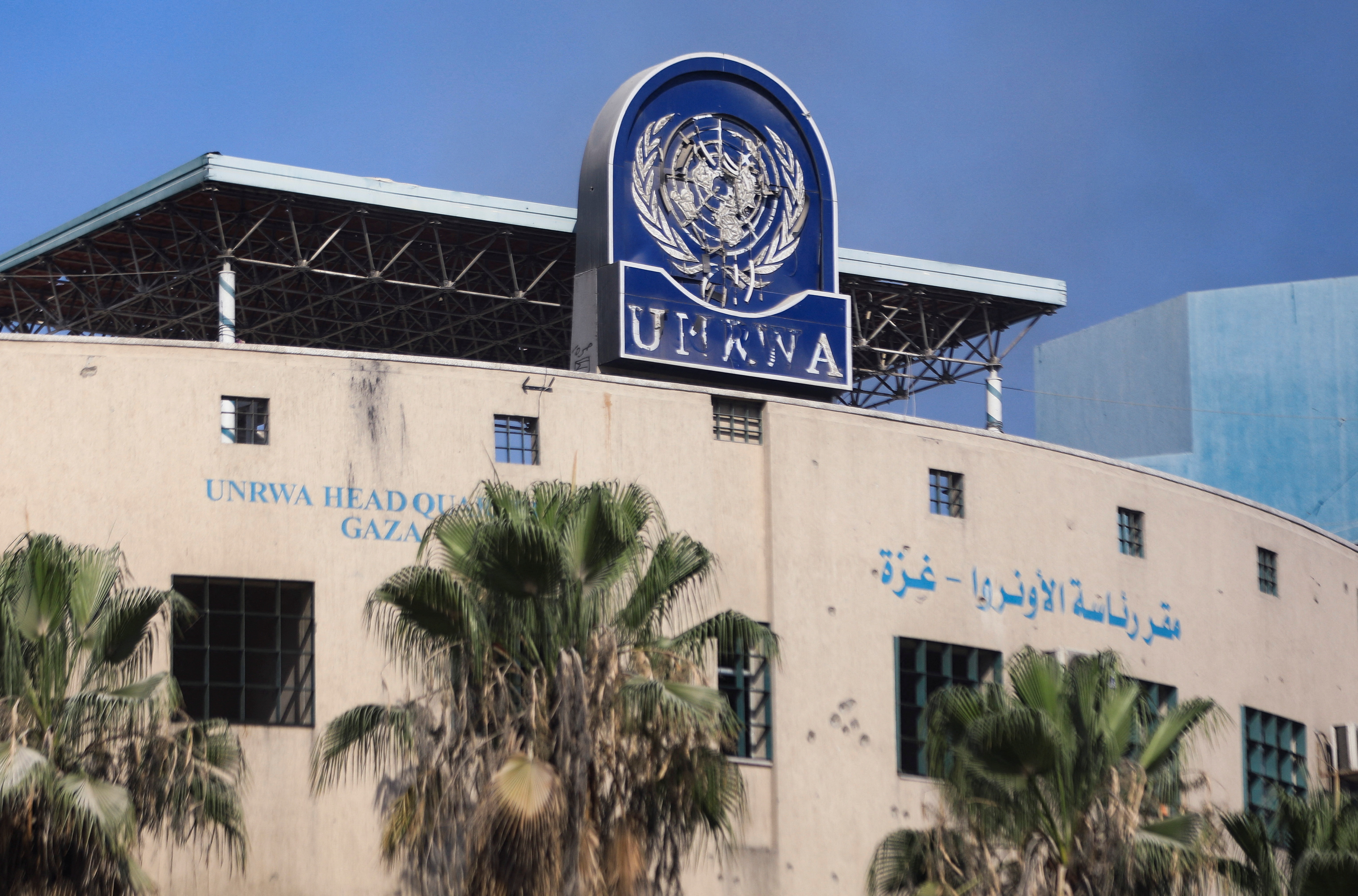 A damaged sign is pictured at the headquarters of UNRWA, following an Israeli raid, amid the Israel-Hamas conflict, in Gaza City, July 12, 2024. REUTERS/Dawoud Abu Alkas