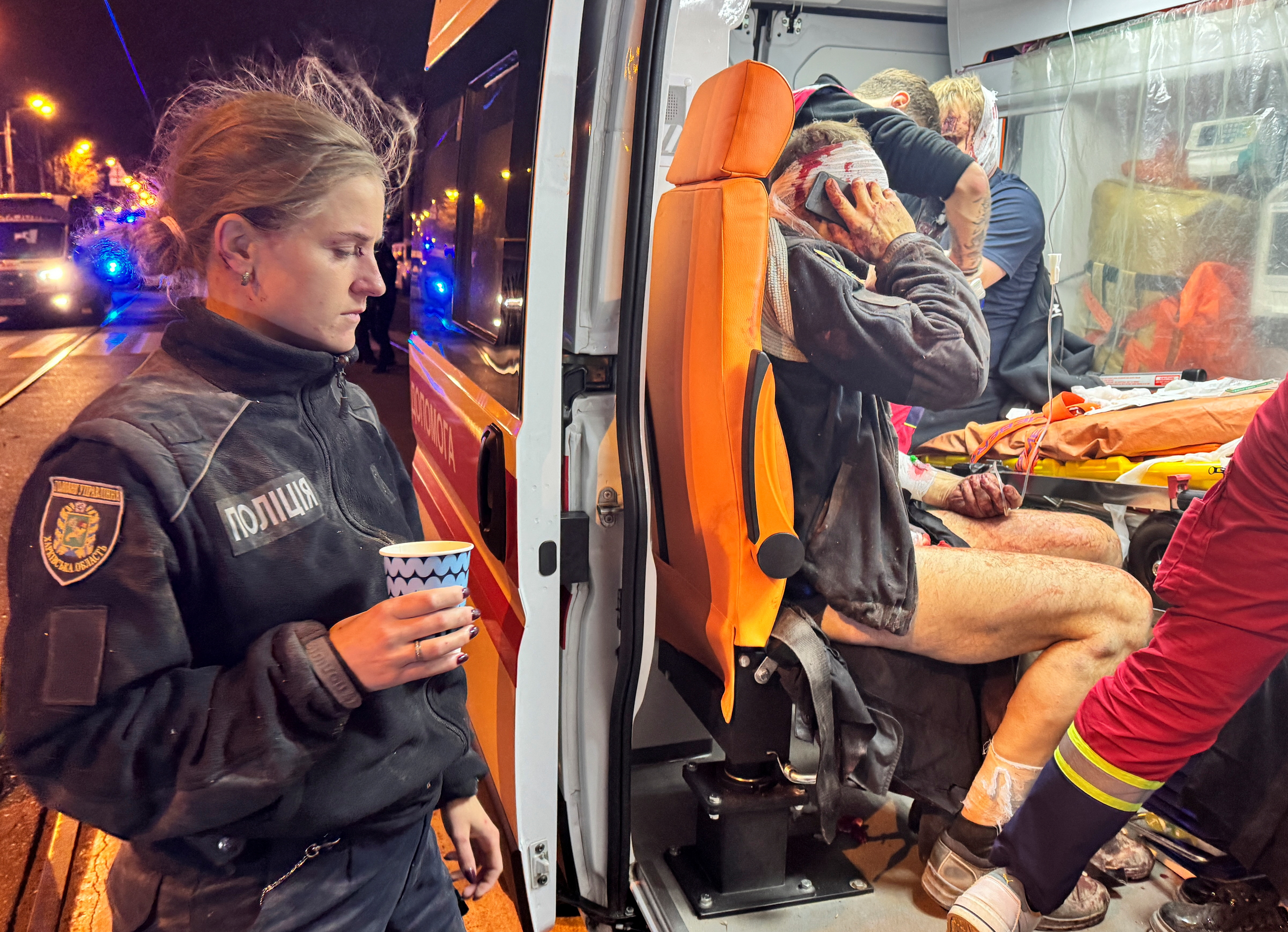 Medical workers treat wounded police officers in an ambulance at a site of a Russian missile strike, amid Russia's attack on Ukraine, in Kharkiv, Ukraine November 1, 2024. REUTERS/Vitalii Hnidyi