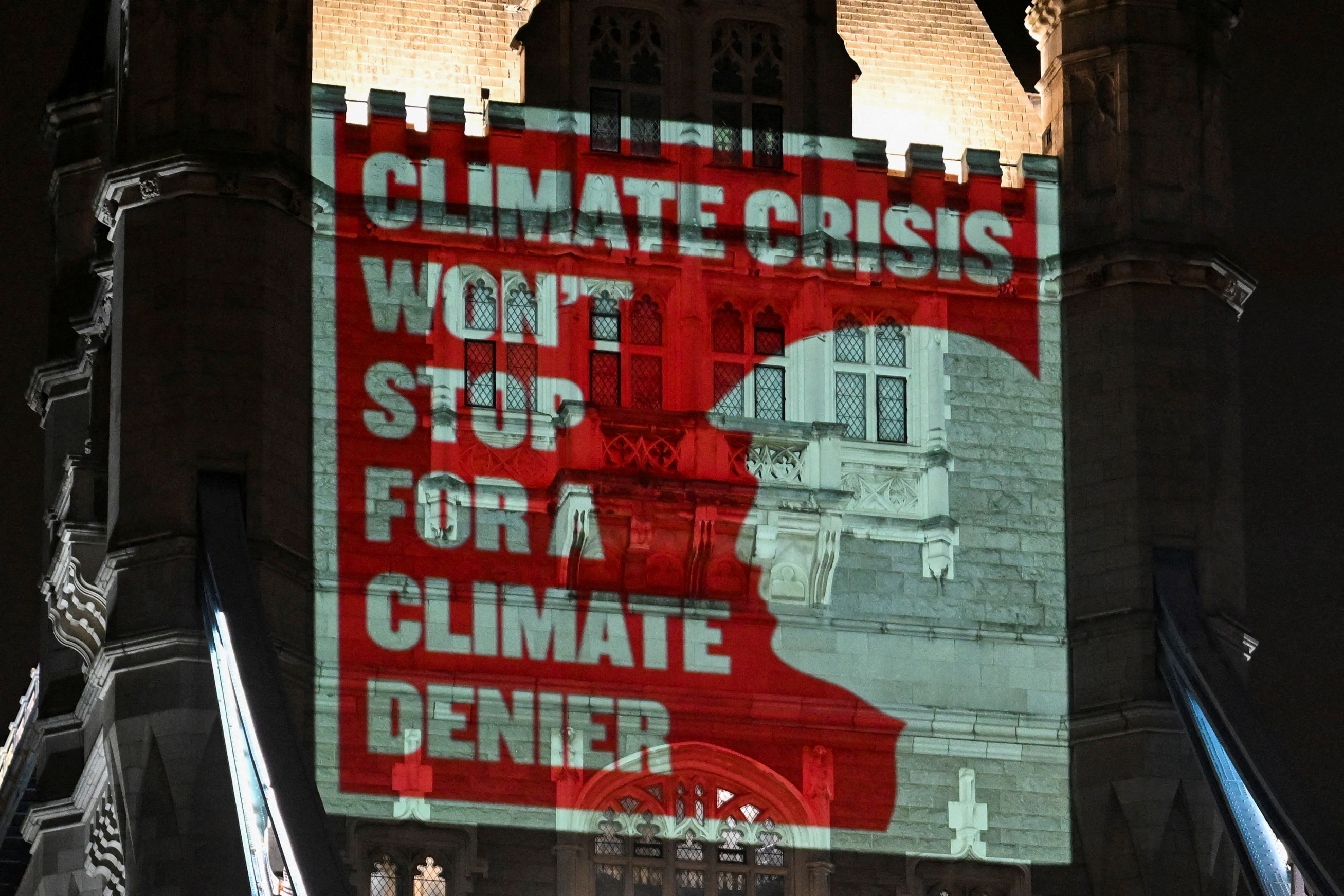 Climate activists project a message onto Tower Bridge with a silhouette of US President-elect Donald Trump, before COP29 climate talks, in London, UK, November 7, 2024