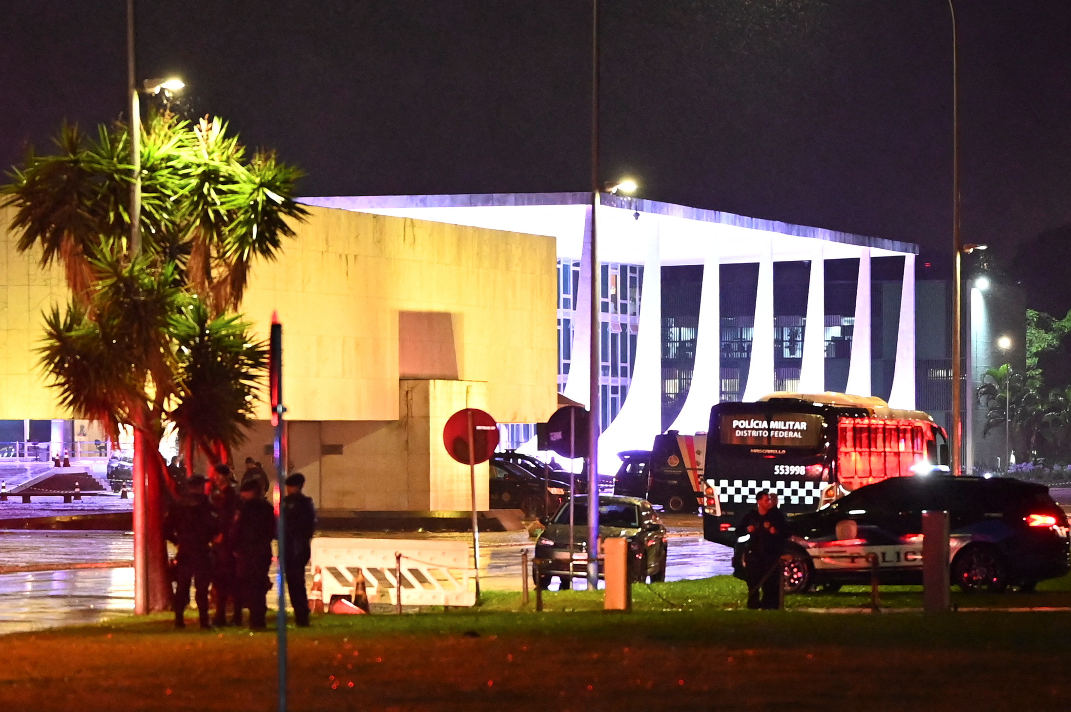 Police and crime-scene vehicles outside Brazil's Three Powers Plaza