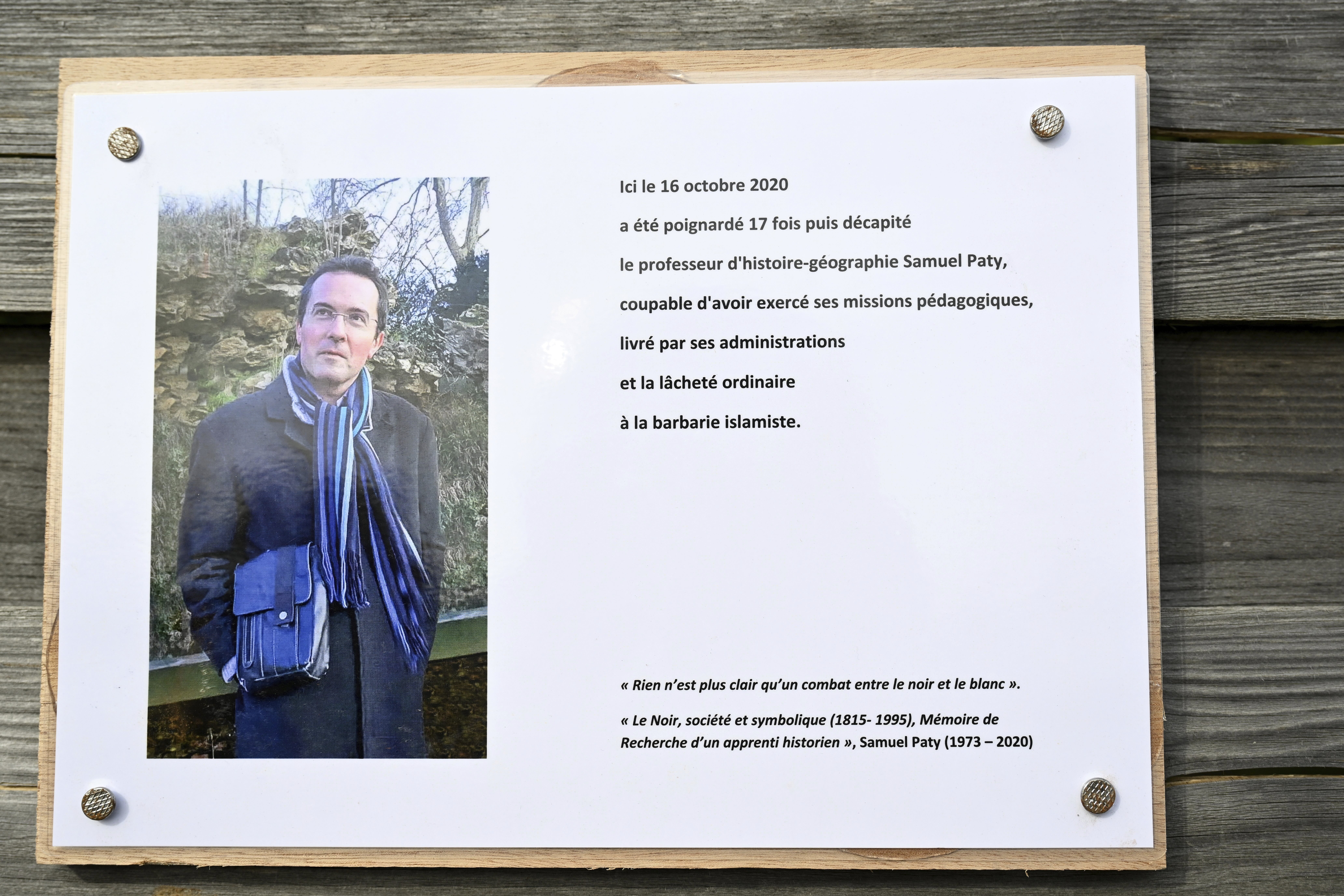 A commemorative plaque for slain teacher Samuel Paty near the Bois d'Aulne school in Conflans-Sainte-Honorine, outside Paris
