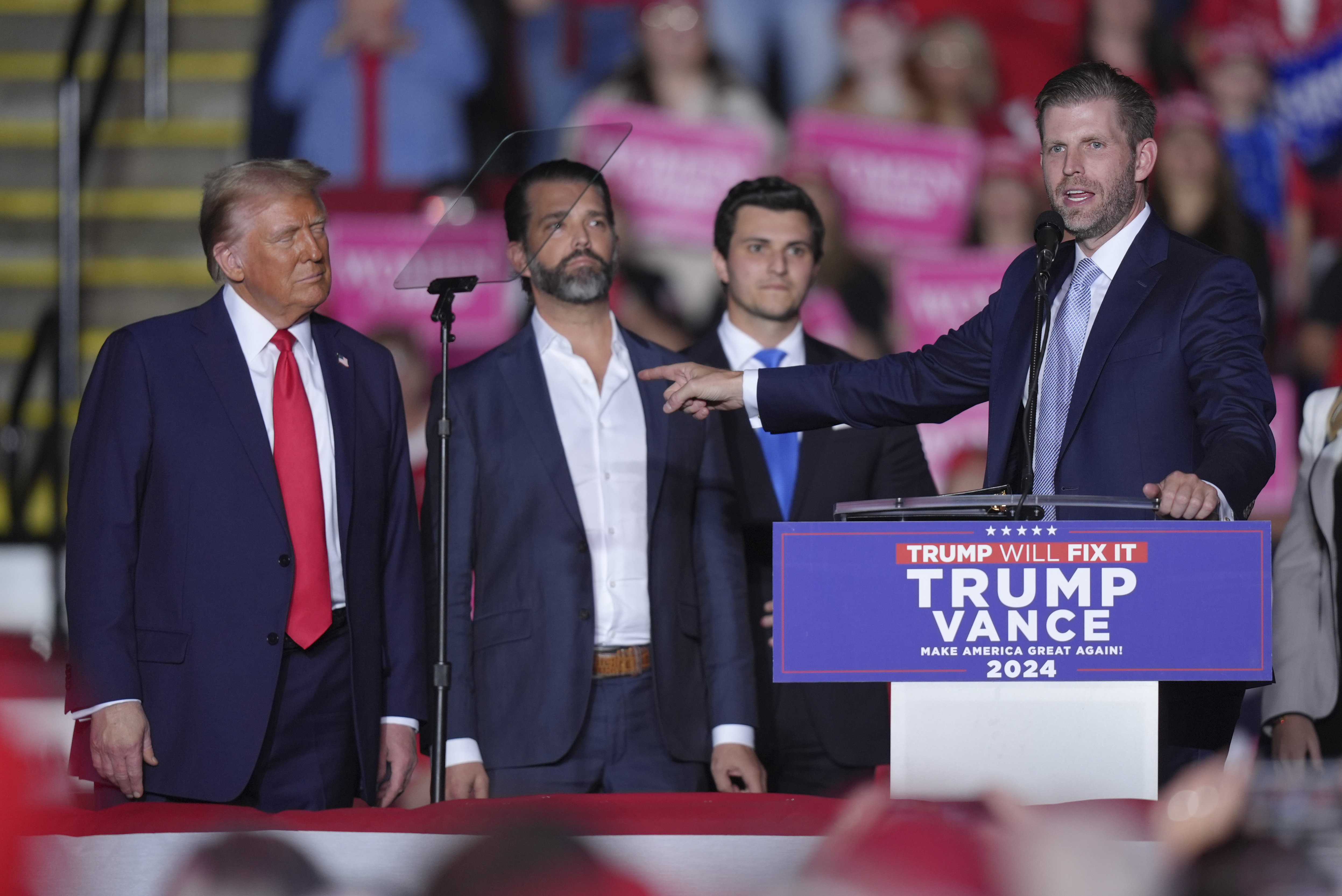 Trump, Donald Trump Jr and Michael Boulos listen as Eric Trump speaks at a campaign rally in Reading, Pennsylvania