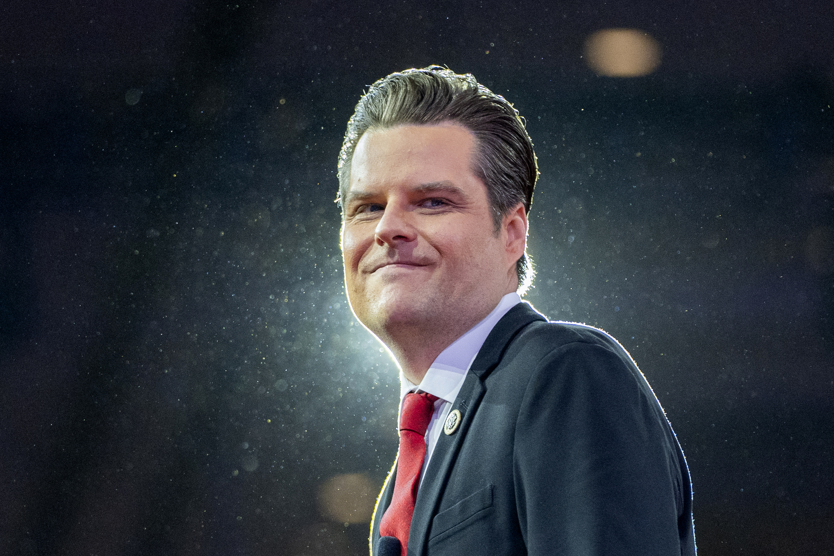 Matt Gaetz smiles at camera with light in background