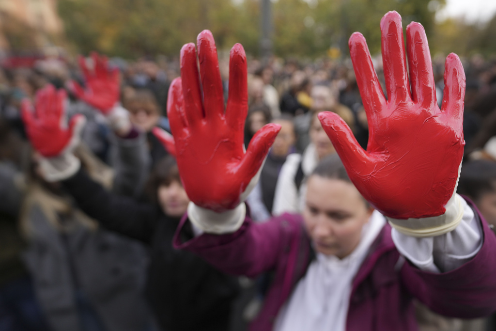 Protesters in Belgrade shout slogans, the red paint on their hands symbolising blood, alleging government corruption was to blame for the collapse of a concrete roof at a recently renovated railway station in Novi Sad