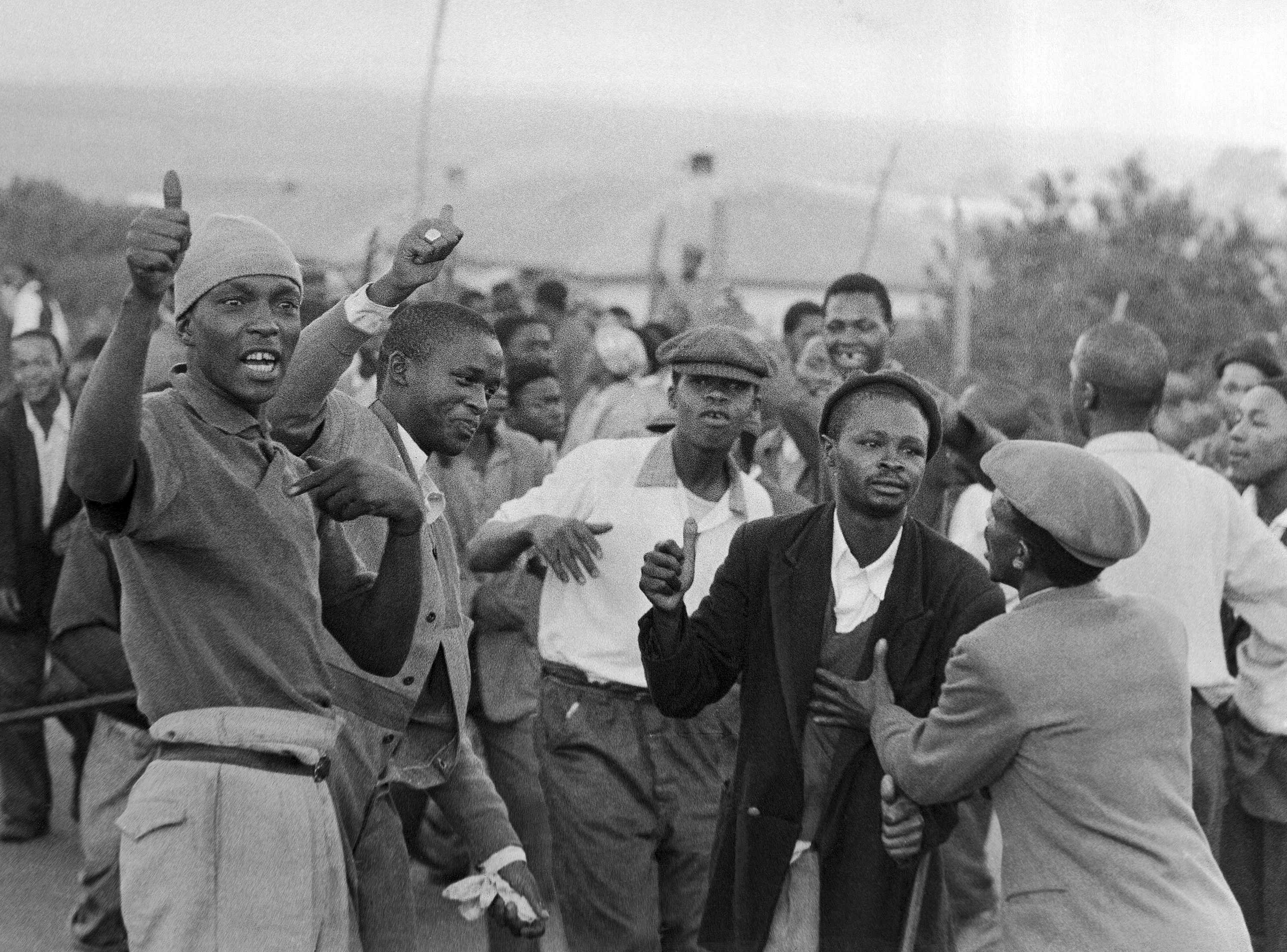 Young Blacks in foreground jeer at passing police in Orlando Township, near Johannesburg, Monday, April 1, 1960 during ?Day of Mourning,? for the victims of the Sharpeville shootings. Protest for the shooting of 80 persons over the racial restrictions spread to a large area of the country [AP]