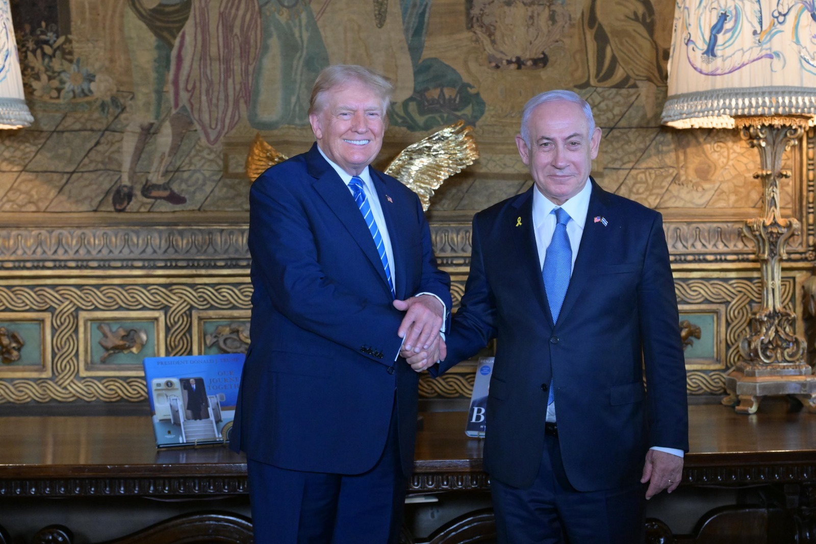 Former US President Donald Trump shakes hands with Israeli Prime Minister Benjamin Netanyahu as they pose for a photo at their meeting at Trump’s Mar-a-Lago resort, in Palm Beach, Florida, United States, on July 26, 2024