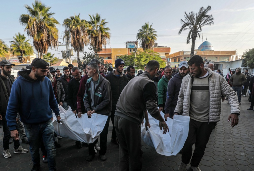 Palestinians carry the covered bodies of the Hirzallah family members, killed in an Israeli airstrike, at Al-Aqsa Martyrs hospital in Deir Al Balah, central Gaza Strip, 08 December 2024. According to the Palestinian Ministry of Health in Gaza, the family was killed in an Israeli airstrike in the southwest of Deir Al Balah town in the central Gaza Strip. More than 45,000 Palestinians and over 1,400 Israelis have been killed, according to the Palestinian Health Ministry and the Israeli Army, since Hamas militants launched an attack against Israel from the Gaza Strip on 07 October 2023 and the Israeli operations in Gaza and the West Bank that followed it. EPA-EFE/MOHAMMED SABER