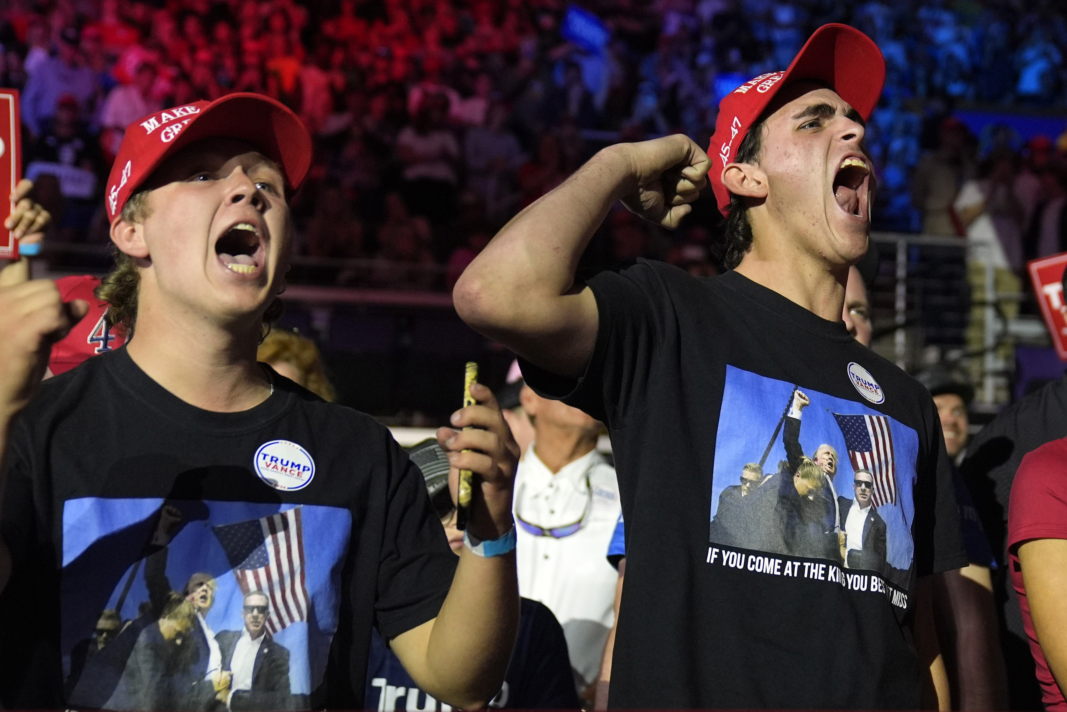 Young Trump supporters react as the Republican arrives for a campaign rally in Greenville, North Carolina on October 21, 2024