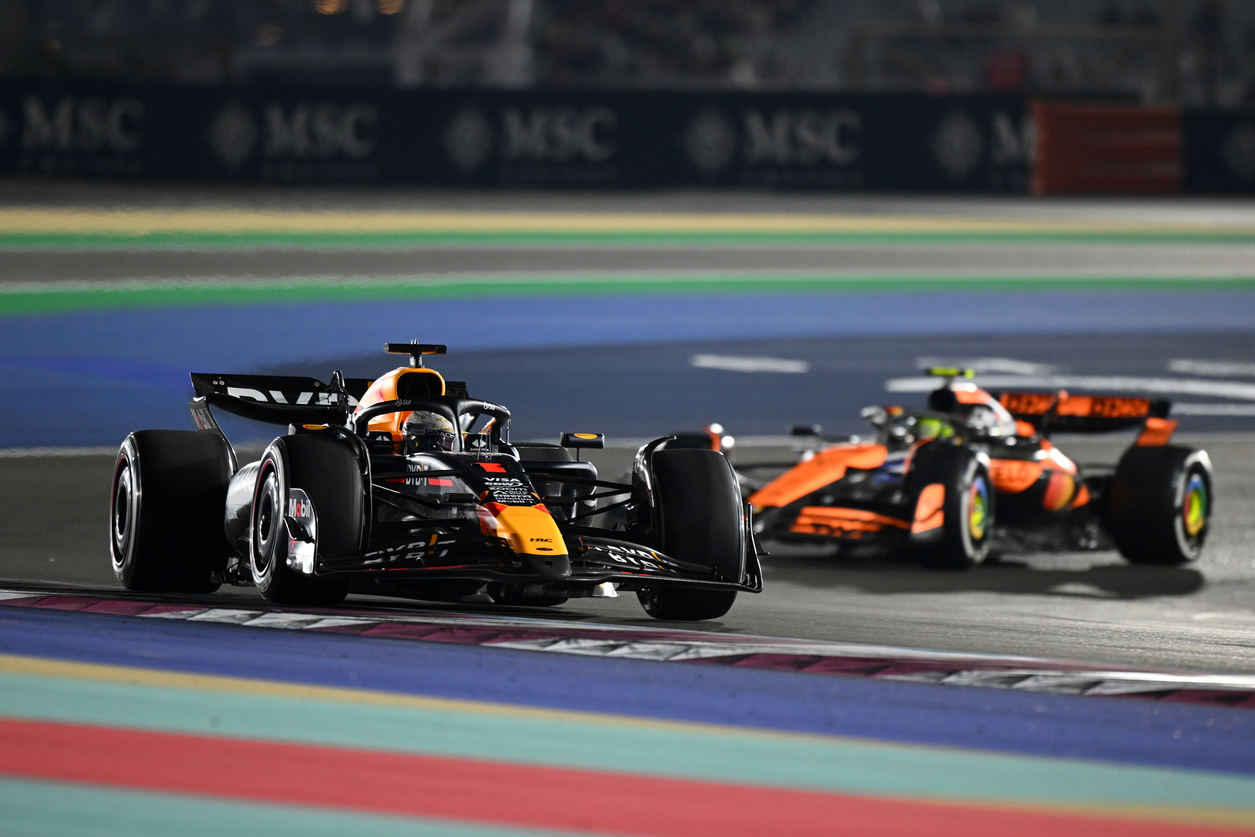 Max Verstappen of the Netherlands, driving the Oracle Red Bull Racing RB20, leads Lando Norris of Great Britain, driving the McLaren MCL38 Mercedes, during the Qatar Grand Prix