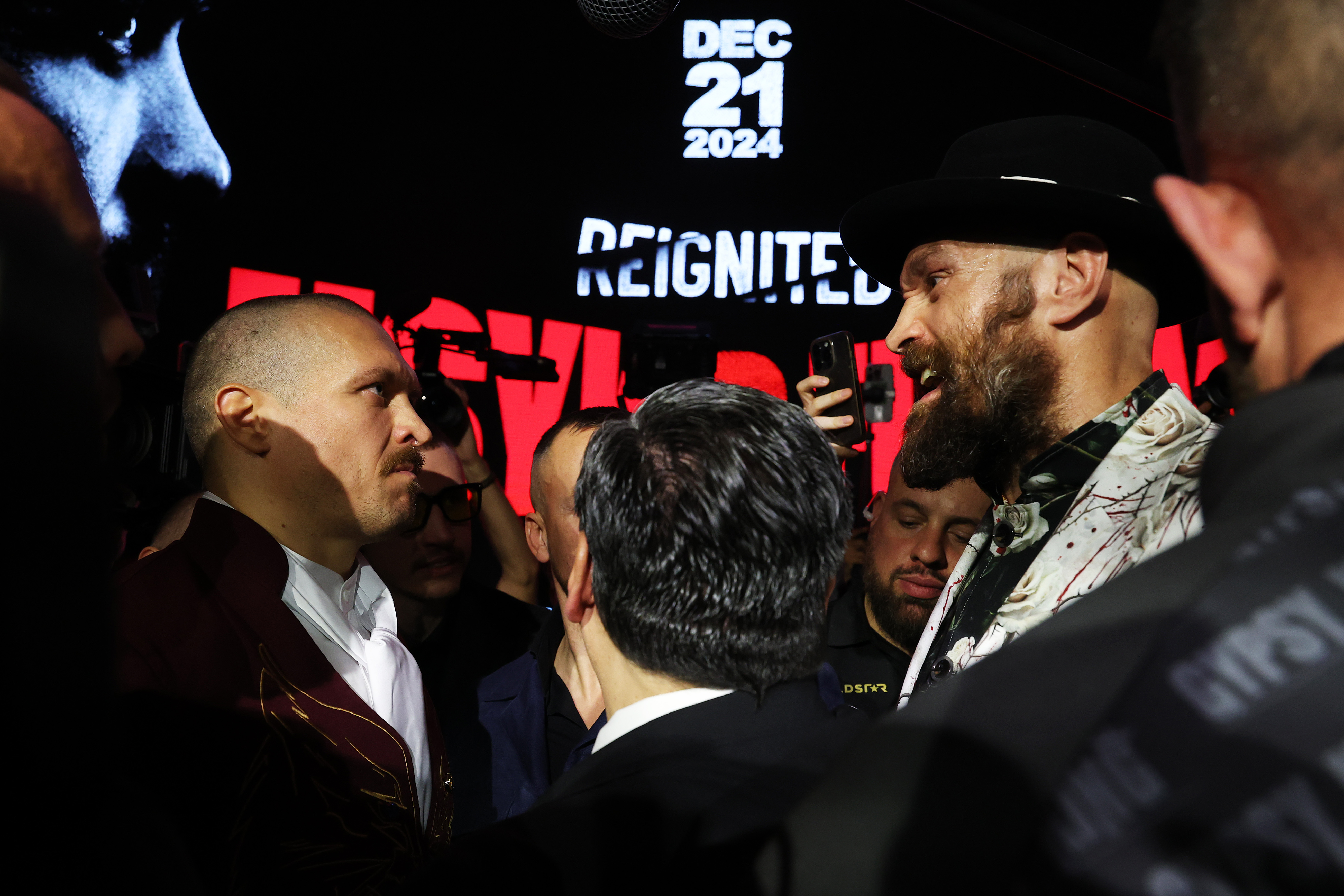 Tyson Fury (R) and Oleksandr Usyk faced-off for a bizarre 11-minute period at their news conference on December 19 in Riyadh, Saudi Arabia
