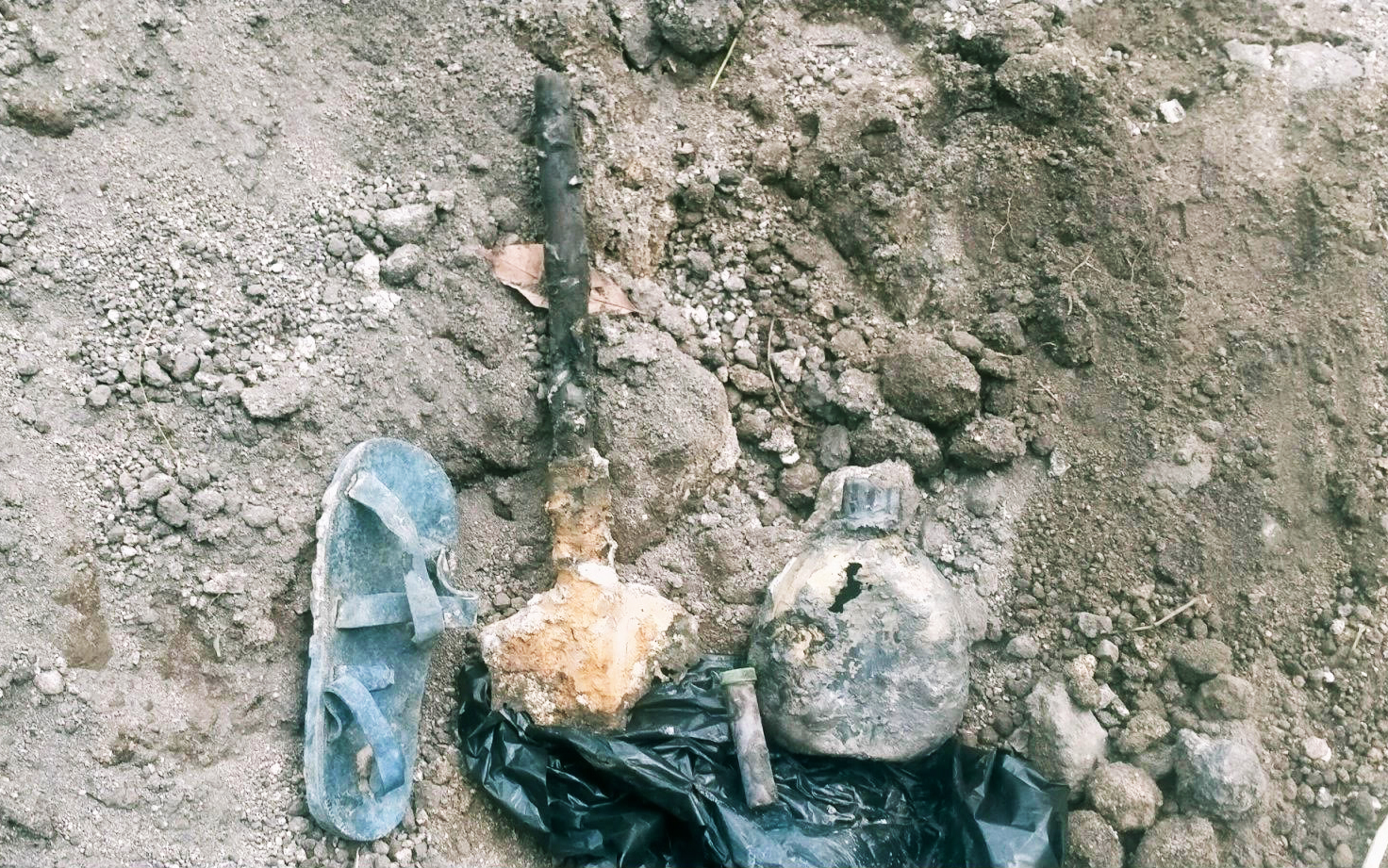 Some of the items found in the first mass grave dig, including a rubber sandal and a purse [Courtesy of Le Hoang Linh]