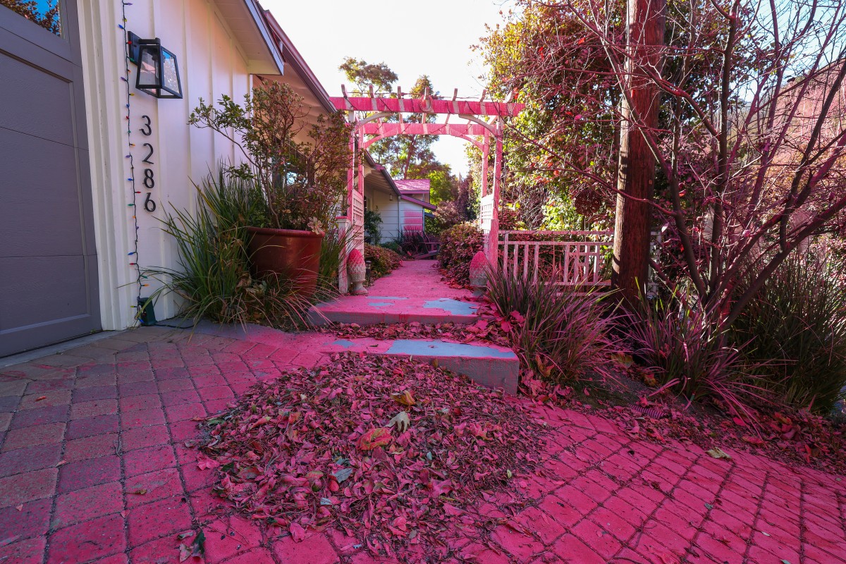 Red flame retardant is seen on a home in the hills of Mandeville Canyon after the Palisades fire burned part of it