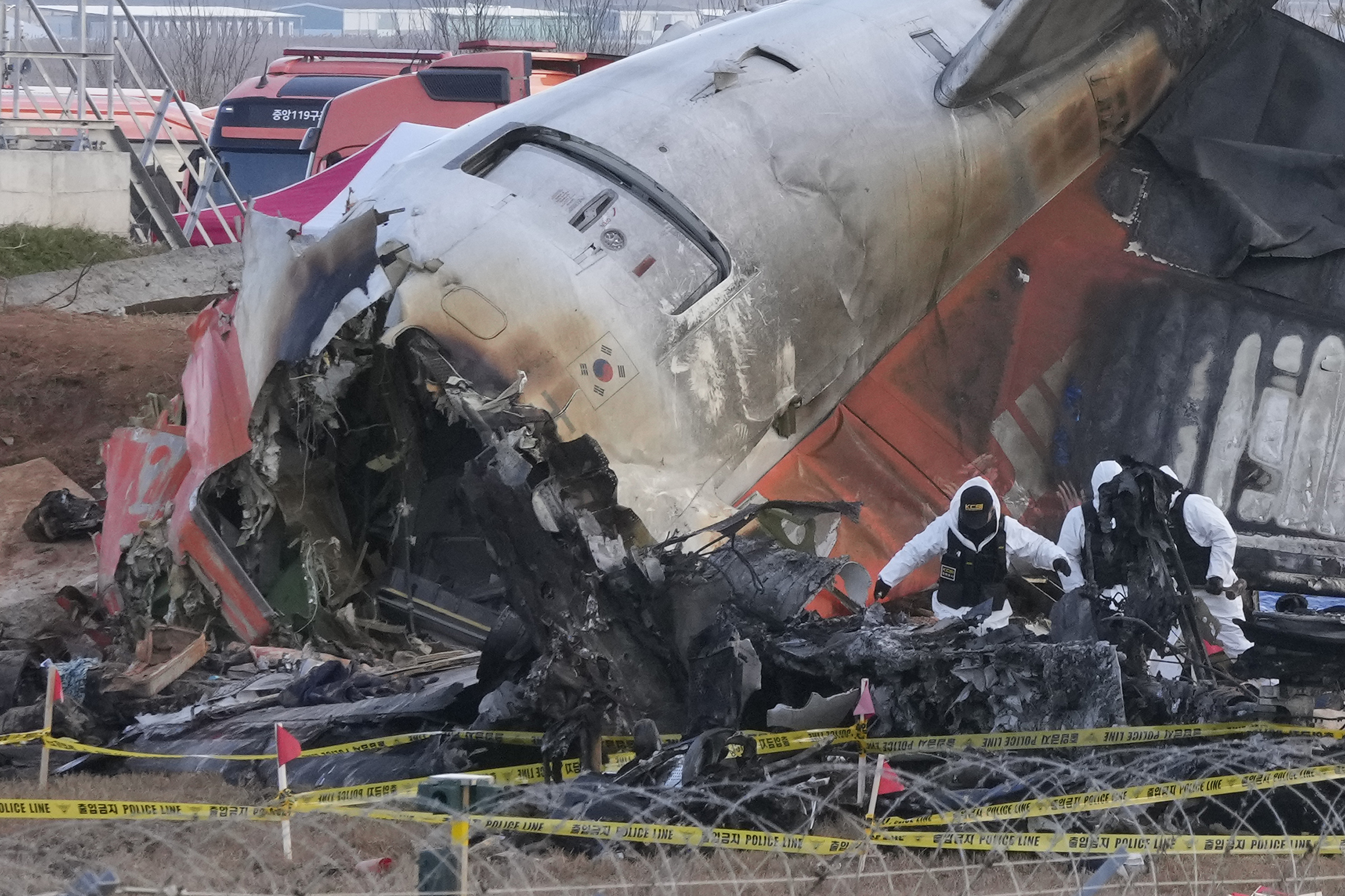 Rescue team members work at the site of a plane crash.