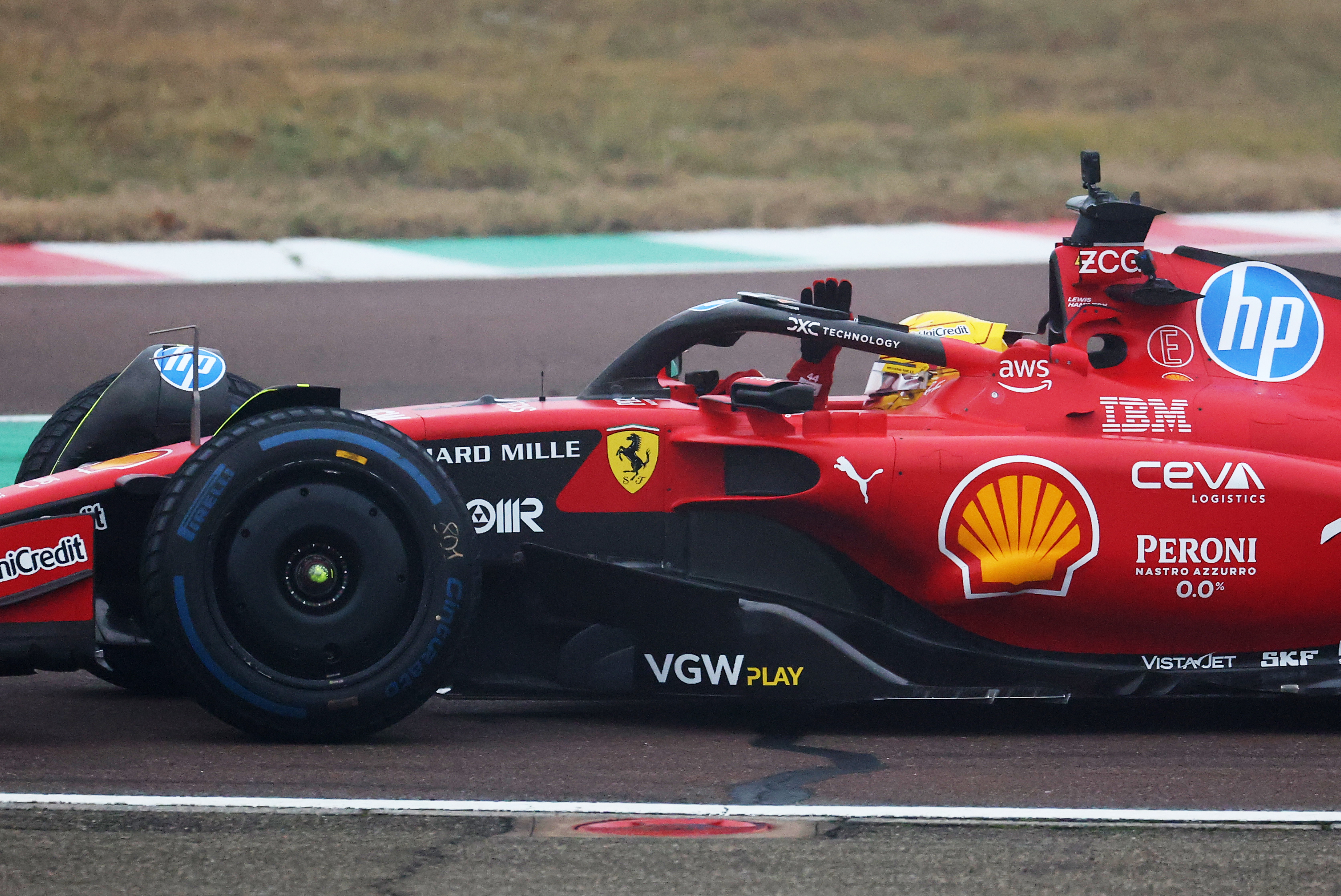 Lewis Hamilton waves to fans.