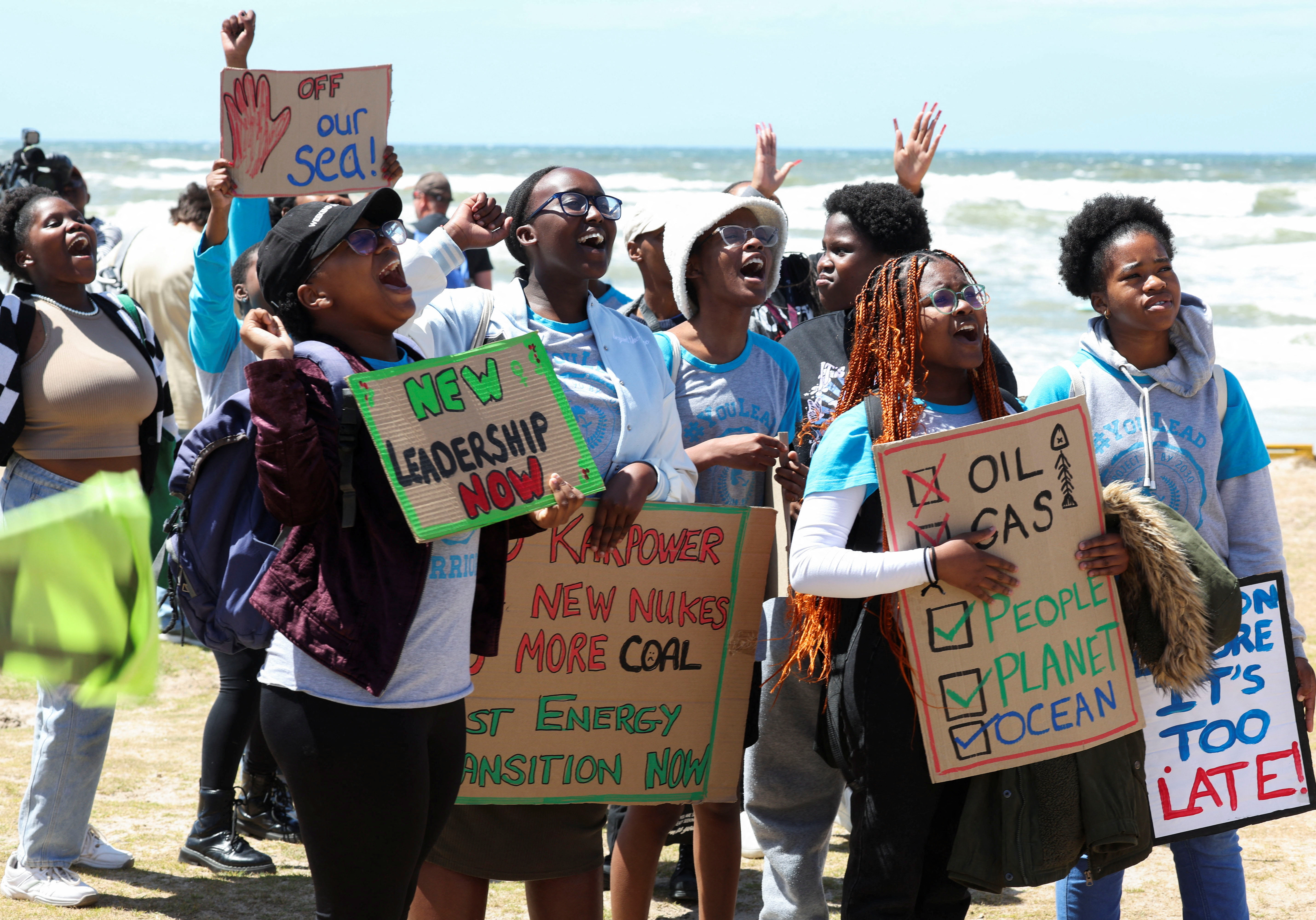 Climate activists hold placards as they demonstrate, calling for climate justice resistance against oil and gas drilling off the South African coastlines [File: Esa Alexander/Reuters]