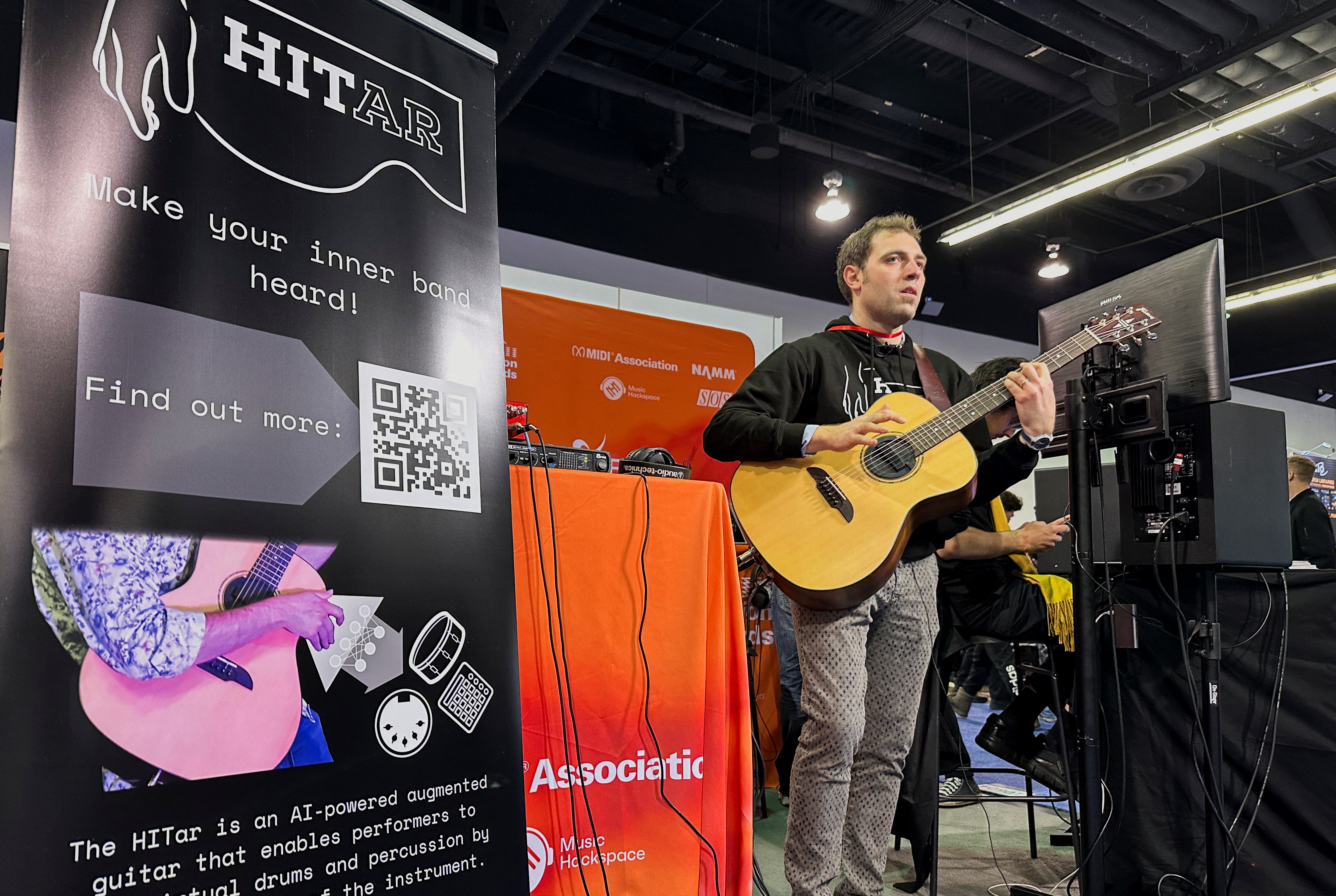 A PhD Student at the Queen Mary University of London demonstrates the 'HITar', an AI-powered augmented guitar