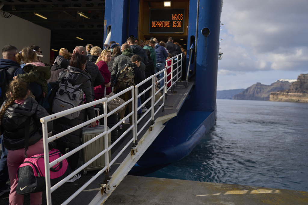 Passengers board a regularly scheduled ferry to Athens’s port of Piraeus, from Santorini, southern Greece on February 3, 2025