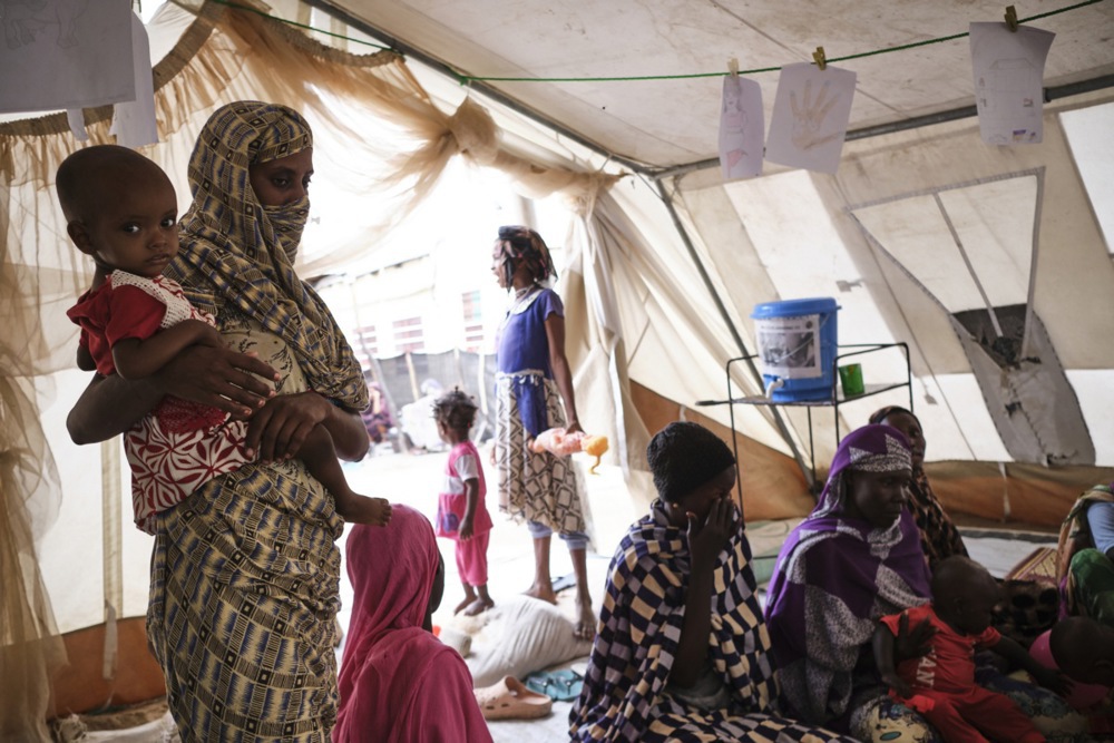A group of women rest in a tent at the Renk Civil Hospital, South Sudan