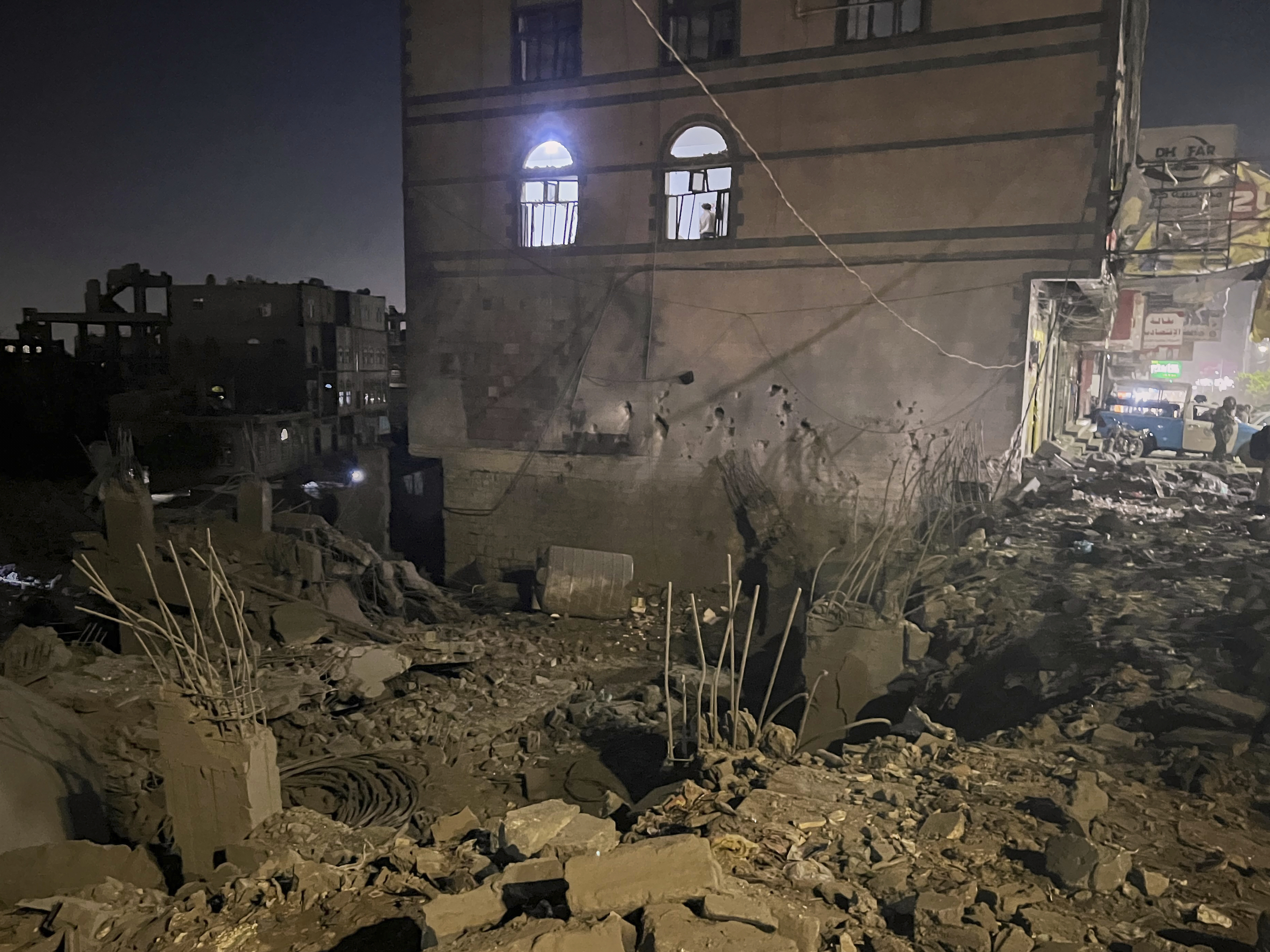 A Yemeni checks debris at his home after US air raid in Sanaa