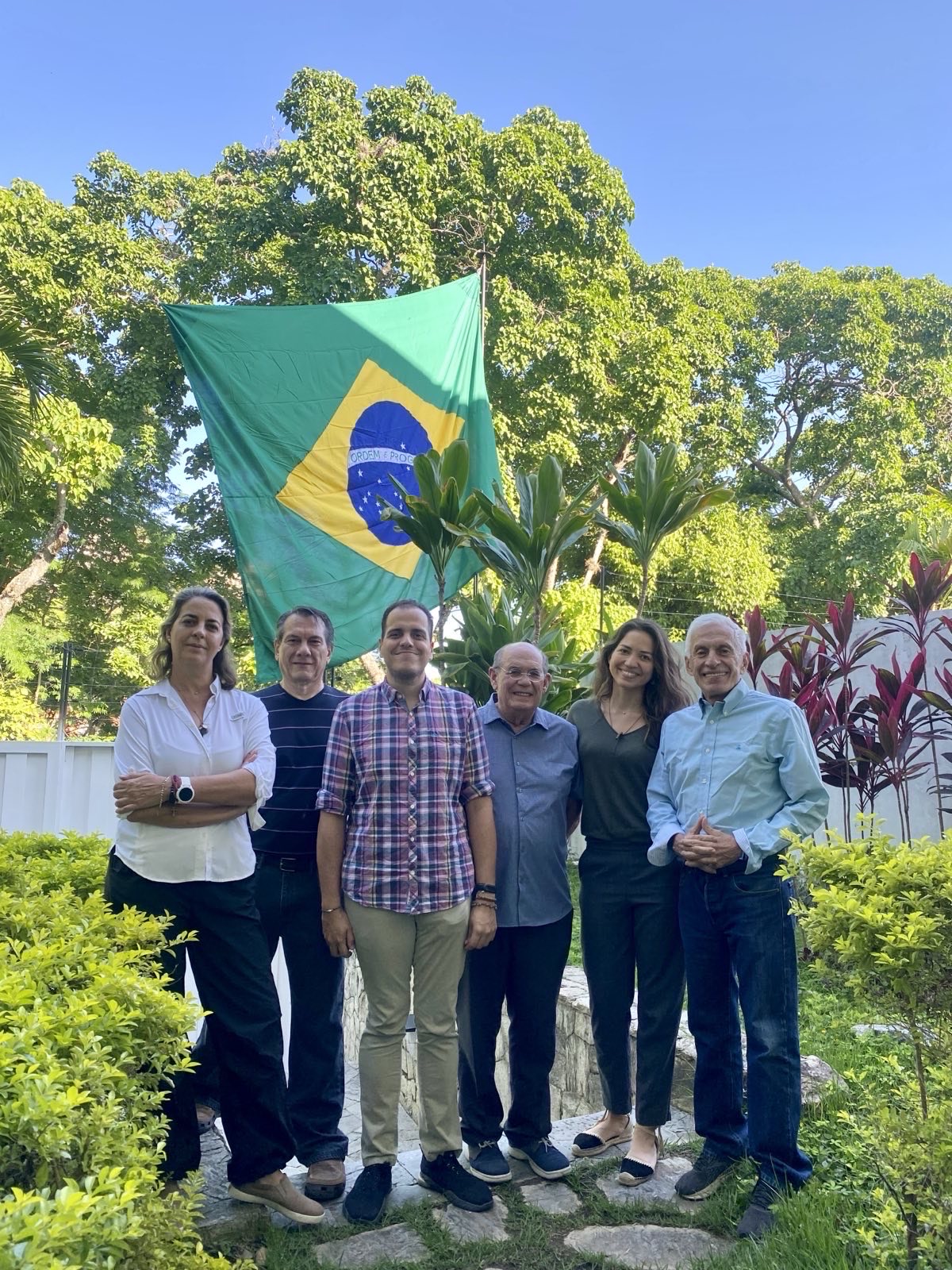 Magalli Meda, Humberto Villalobos, Pedro Urruchurtu, Omar Gonzalez, Claudia Macero and Fernando Martinez Mottola pose under a Brazilian flag [Courtesy of Magalli Meda]