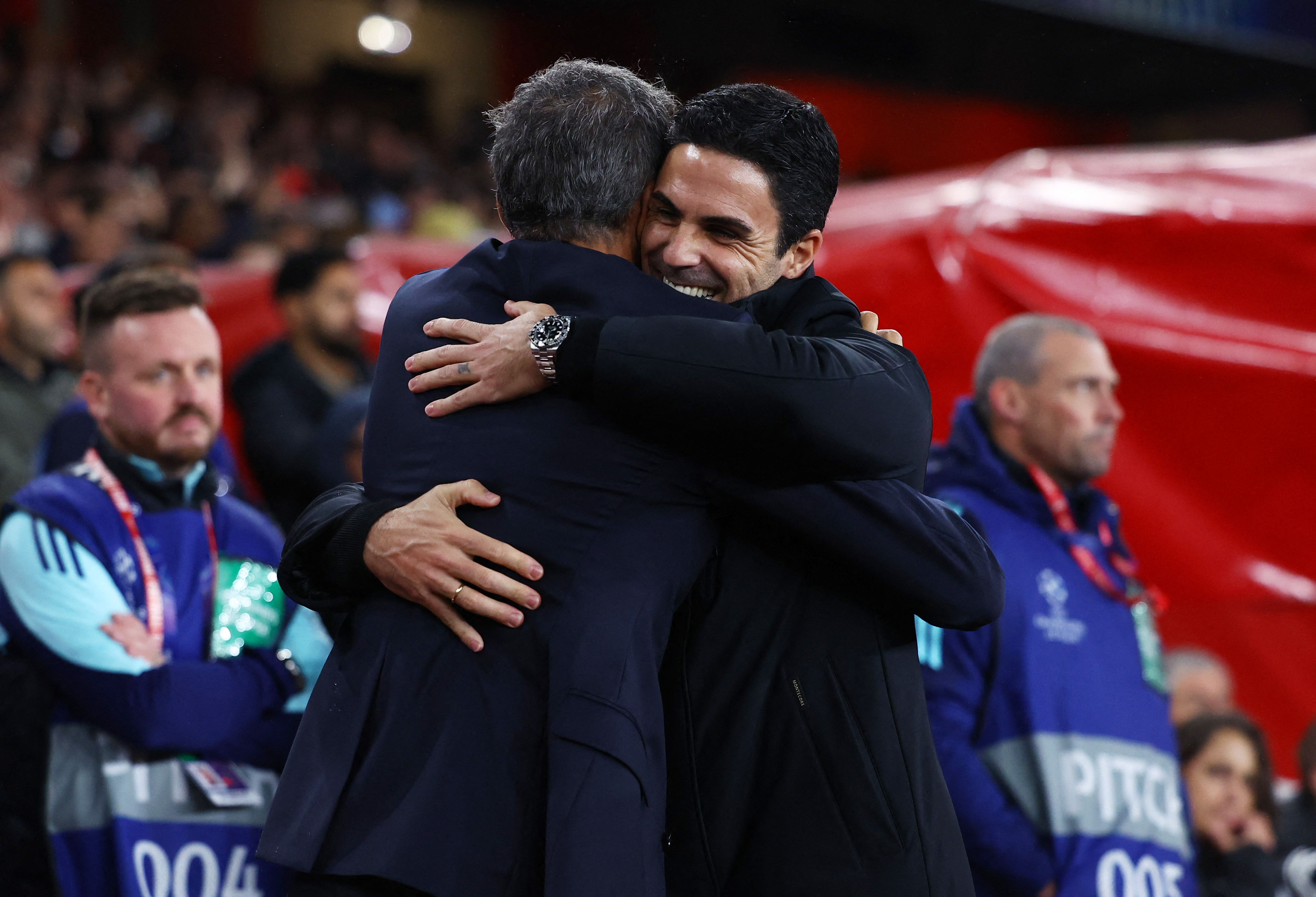PSG coach Luis Enrique, left, and Arsenal manager Mikel Arteta hug before their UEFA Champions League group match on October 1, 2024