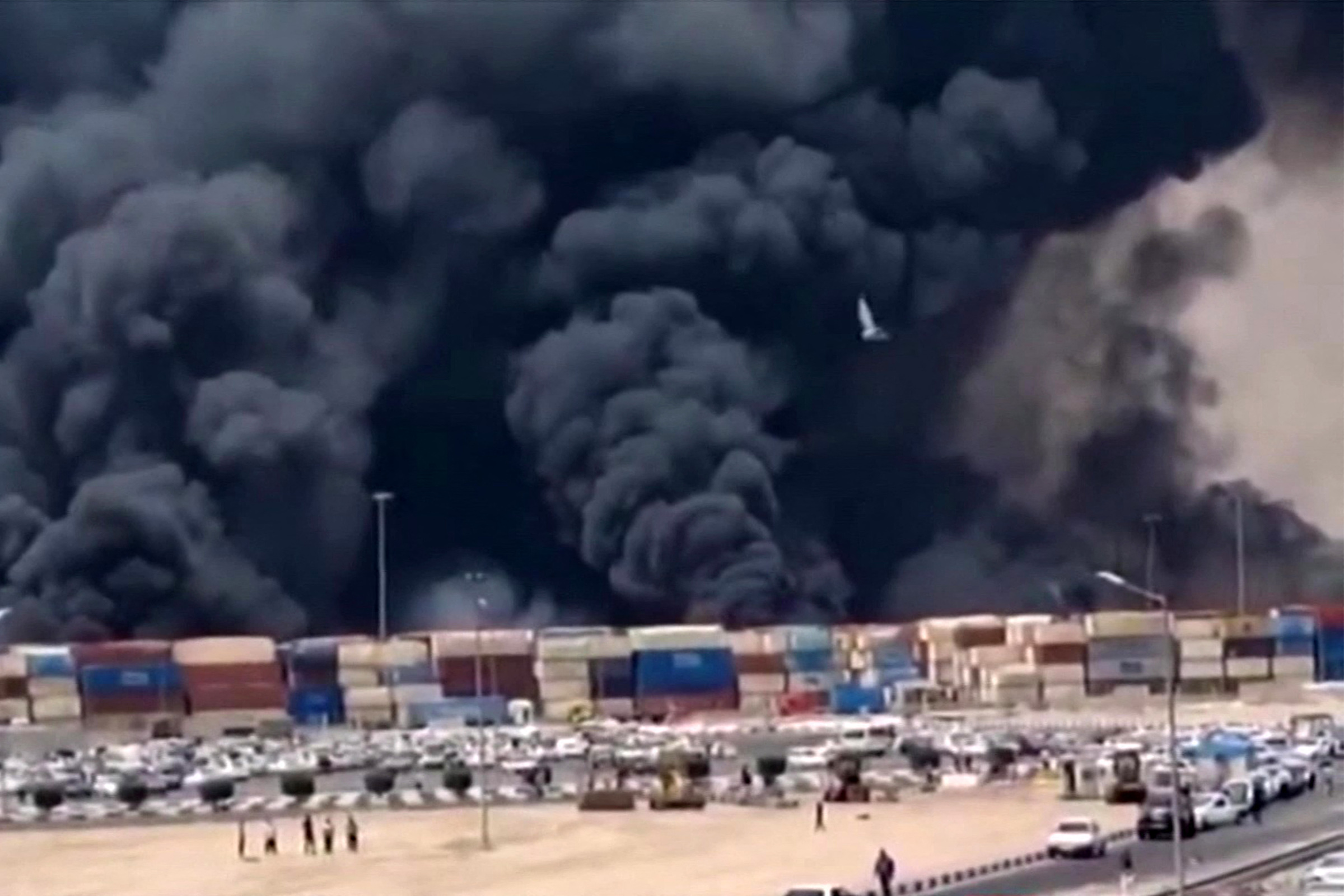 TOPSHOT - This image grab taken from footage released by the state television Islamic Republic of Iran Broadcasting News (IRIBNEWS) on April 26, 2025 shows thick black smoke billowing following an explosion at the Shahid Rajaee port dock southwest of Bandar Abbas in the Iranian province of Hormozgan. Several containers exploded on April 26 at Iran's largest commercial port, authorities said, causing a major blast and fire, and leaving several people injured. Shahid Rajaee, more than 1,000 kilometres (620 miles) south of the capital, is the most advanced container port in Iran, according to the official IRNA news agency. (Photo by IRIBNEWS / AFP) / RESTRICTED TO EDITORIAL USE - MANDATORY CREDIT "AFP PHOTO / HO / IRIBNEWS" - NO MARKETING NO ADVERTISING CAMPAIGNS - DISTRIBUTED AS A SERVICE TO CLIENTS /NO RESALE/ NO ACCESS ISRAEL MEDIA/PERSIAN LANGUAGE TV STATIONS/ OUTSIDE IRAN/ STRICTLY NO ACCESS BBC PERSIAN/ VOA PERSIAN/ MANOTO-1 TV/ IRAN INTERNATIONAL/RADIO FARDA