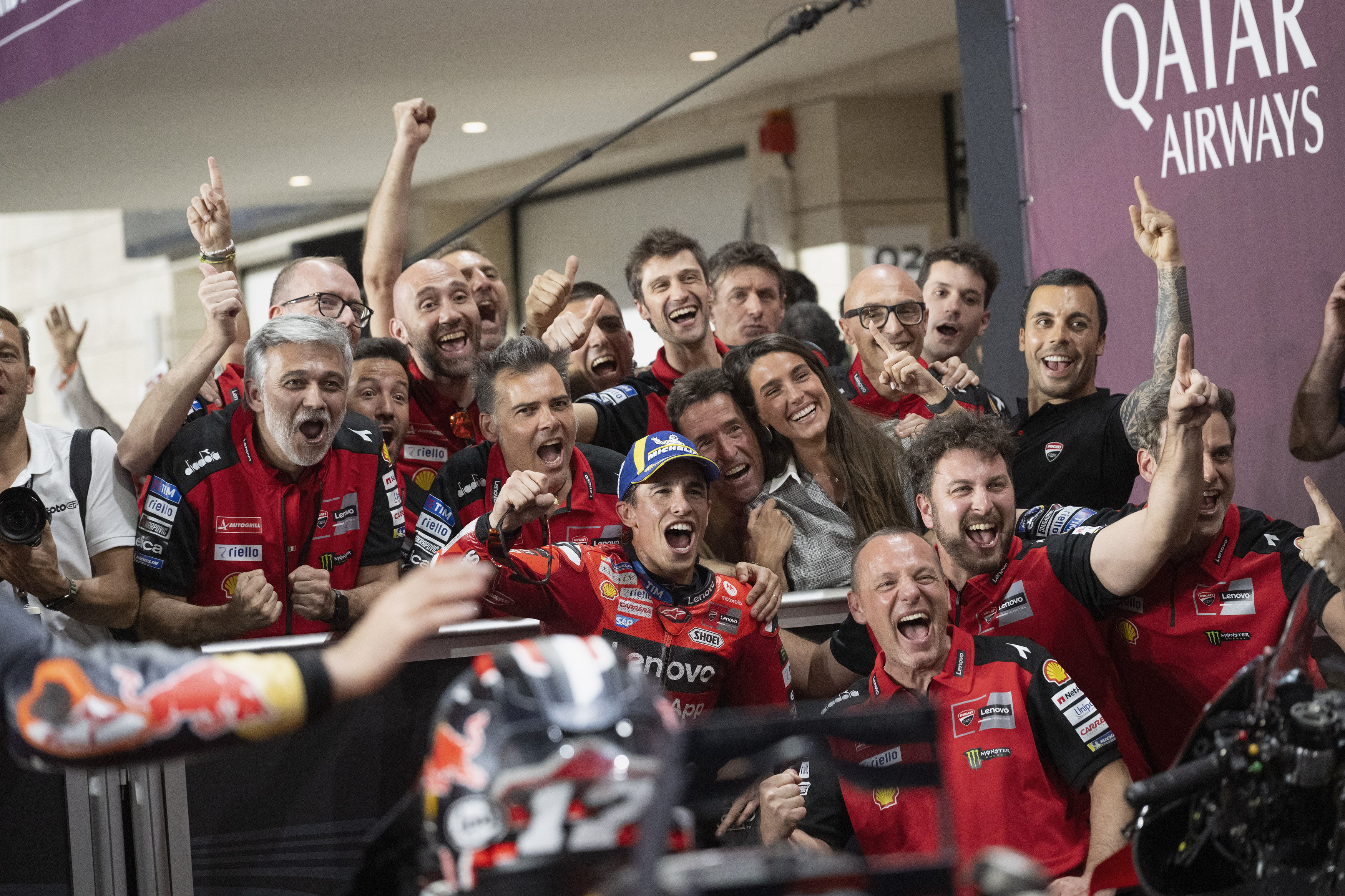 Marc Marquez, centre, and the Ducati Lenovo Team celebrate the Qatar GP victory after the race