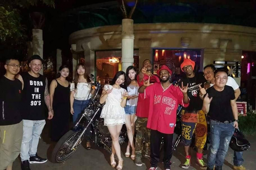 Stak stands with fans outside a club in Shanghai in 2019 [Courtesy of Jo Stak]