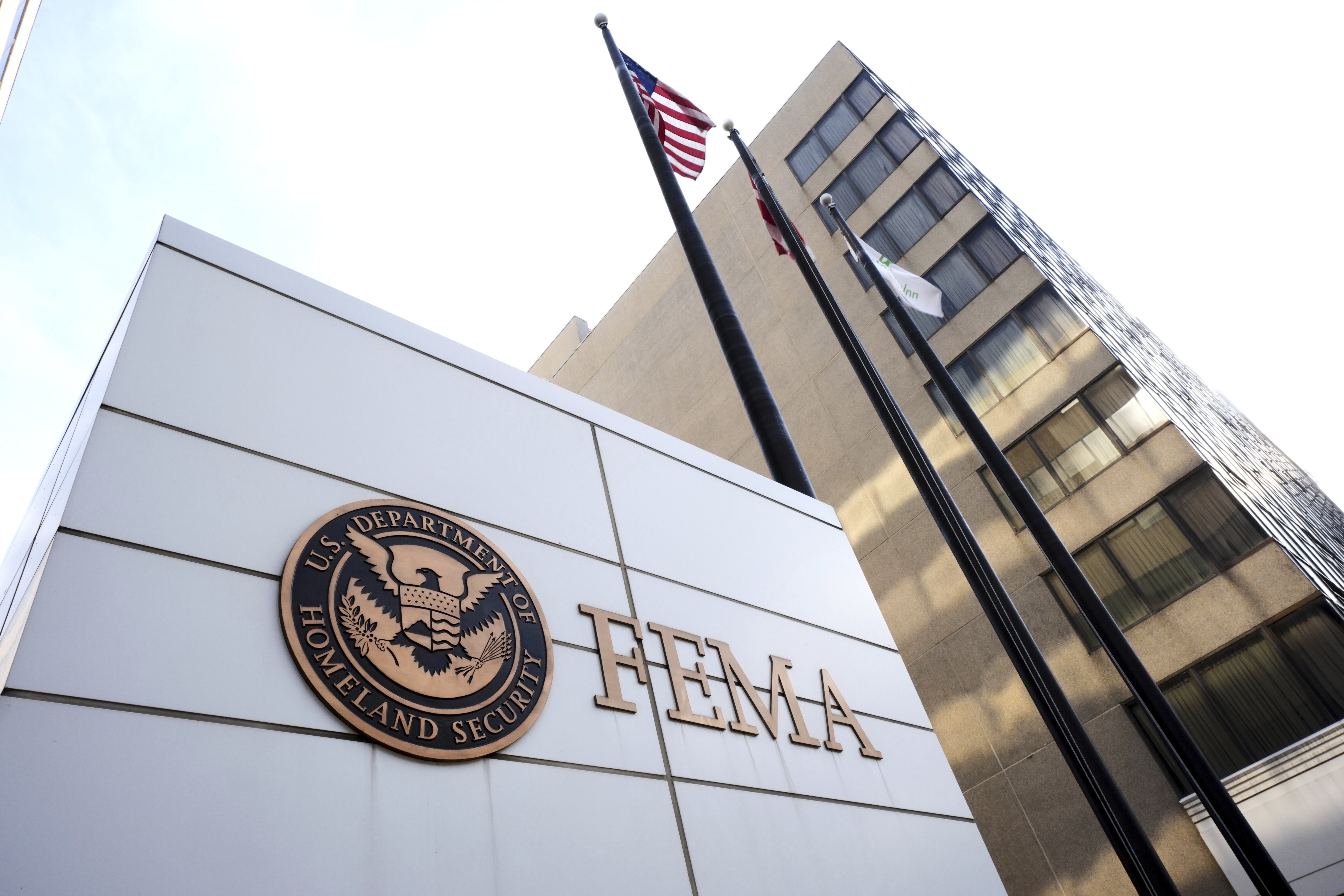 The outside of FEMA's headquarters, where its name and logo are visible on a sign.