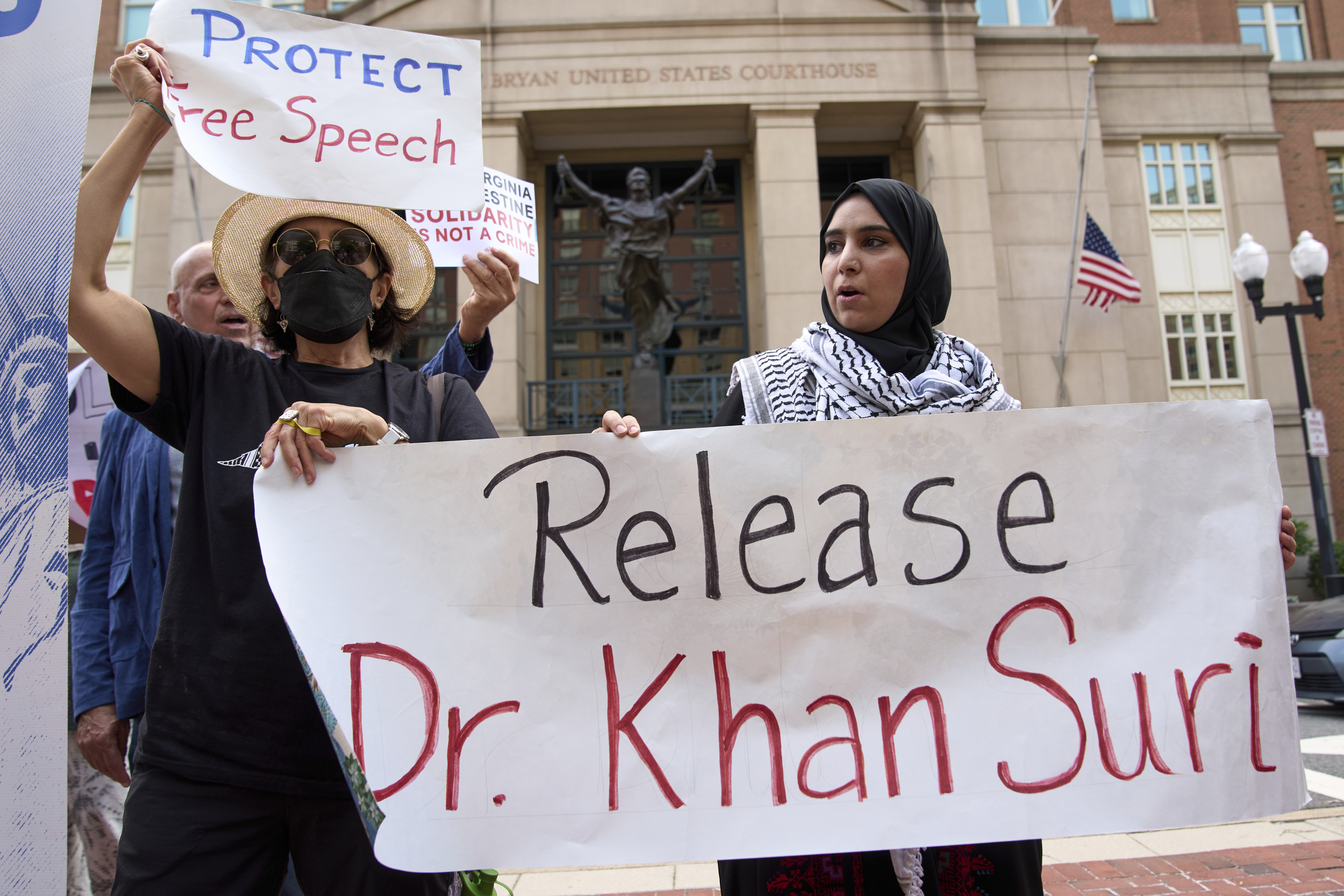 Mapheze Saleh, right, wife of arrested and detained Georgetown University scholar Badar Khan Suri, holds a sign calling for her husband’s release after speaking at a news conference following his hearing at Federal District Court for the Eastern District of Virginia, on May 1, 2025 [Jacquelyn Martin, AP Photo]
