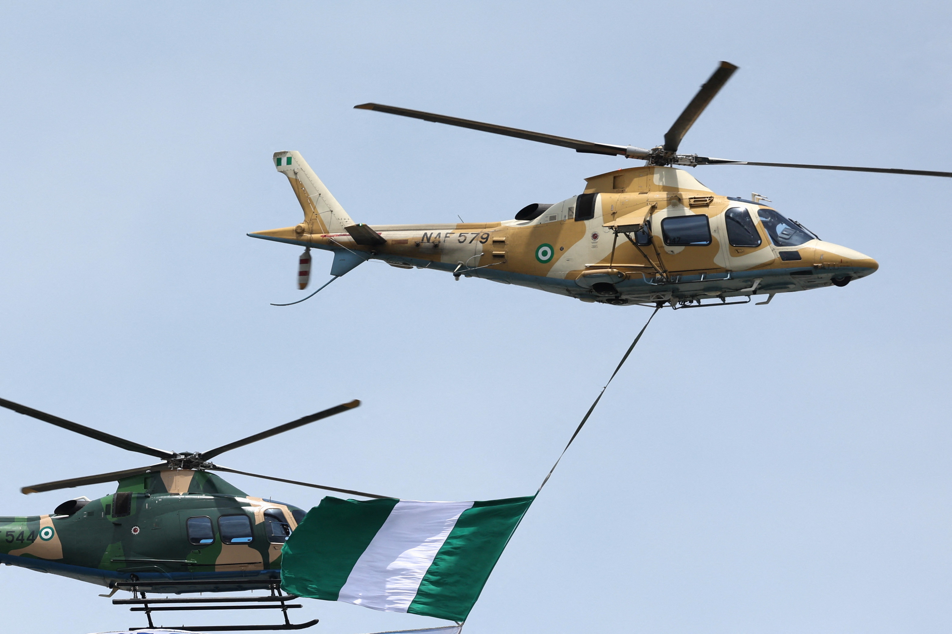 Nigerian Air Force helicopters hover near Eko Atlantic City during the 4th African Air Forces Forum to commemorate the Nigerian Air Force's 61st Anniversary, as part of the efforts to neutralize the insurgency in the northern part of Nigeria, in Lagos, Nigeria, May 23, 2025. REUTERS/Sodiq Adelakun