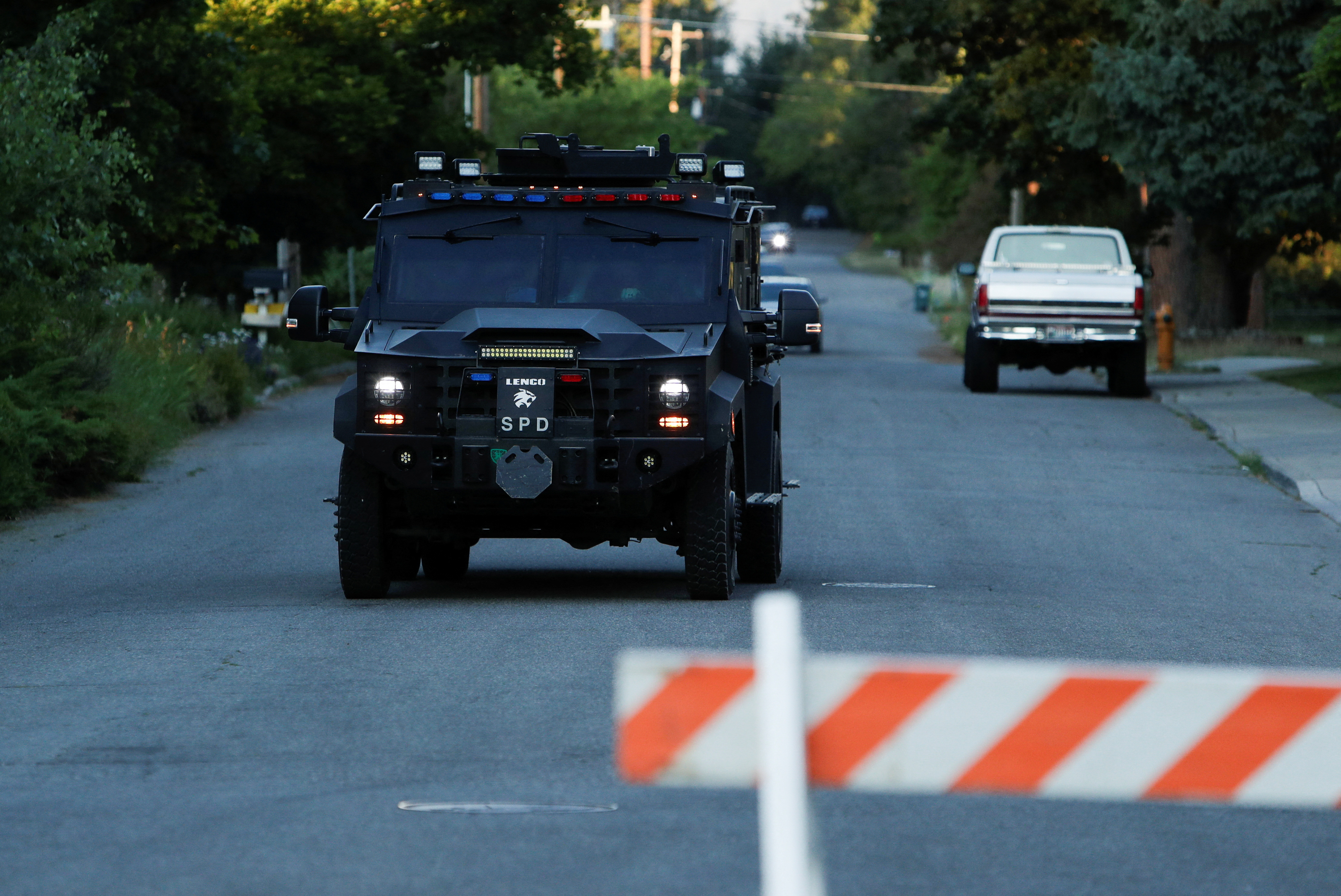 An armoured police vehicle leaves an area where firefighters were attacked while responding to a fire in the Canfield Mountain area outside Coeur d'Alene, Idaho, US