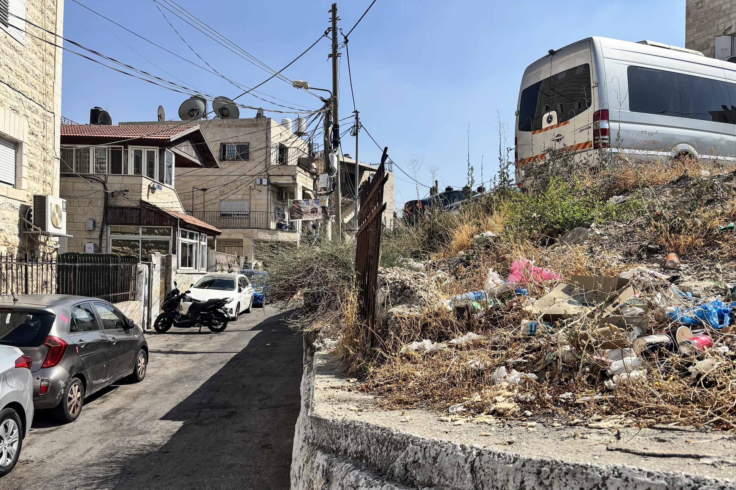 A pizza box is all that remains from the at-Tur shooting, beside the alley where the shooting occurred near the Abu Juma’ family home [Al Jazeera]