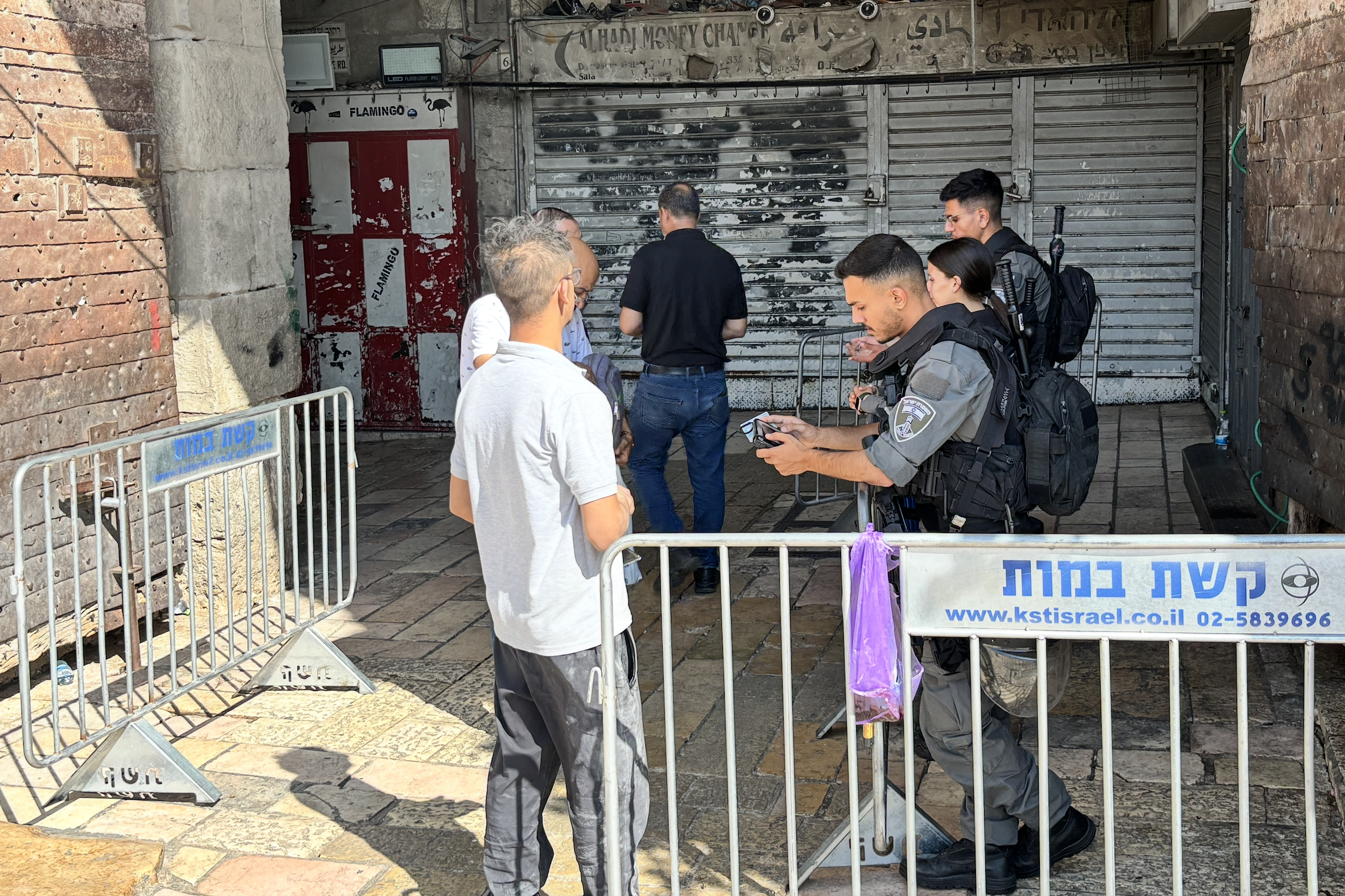 Israeli border police check the identity papers of Palestinians at Damascus Gate to the Old City of Jerusalem, only allowing residents to enter [Al Jazeera]